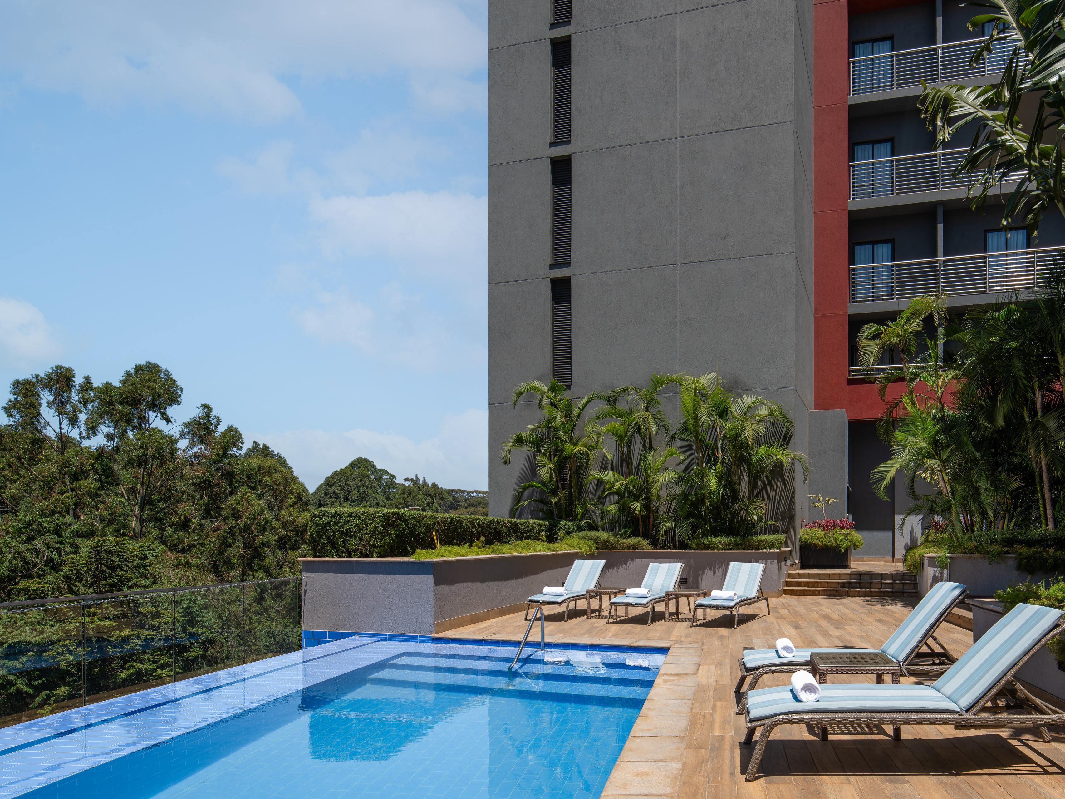 Cool off from the Nairobi sun with a refreshing dip in our family-friendly outdoor pool, a unique feature among hotels in Nairobi. With sunbeds set for relaxation and nature serenading your stay, it's a slice of paradise. Our pool bar menu tempts with bite-sized treats and crafted cocktails, elevating your poolside experience.