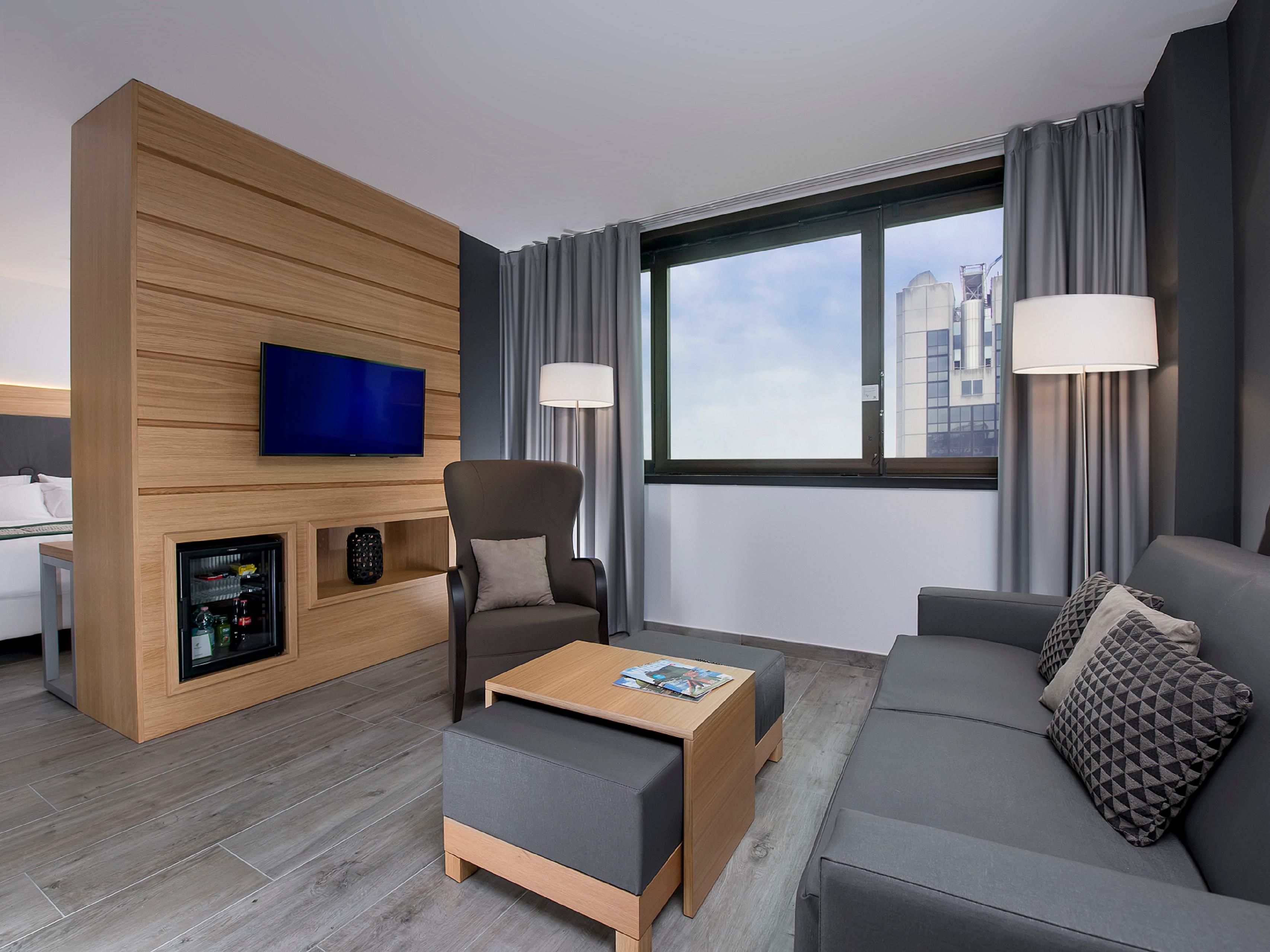Book our newly decorated suite and enjoy a deluxe stay. A king bed and a living area with sofa bed, wood effect gres tiles and a large walk in shower.