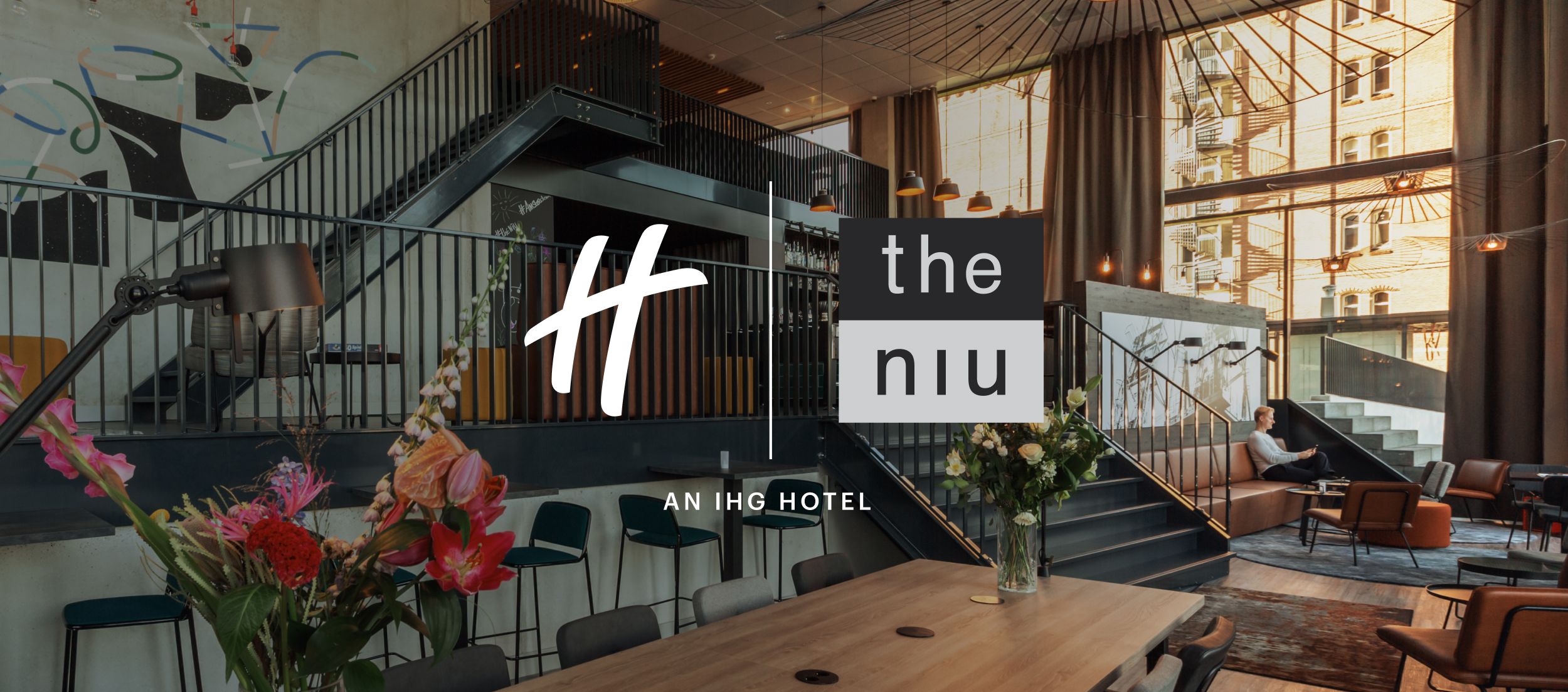 Large room with tables and chairs and lots of windows