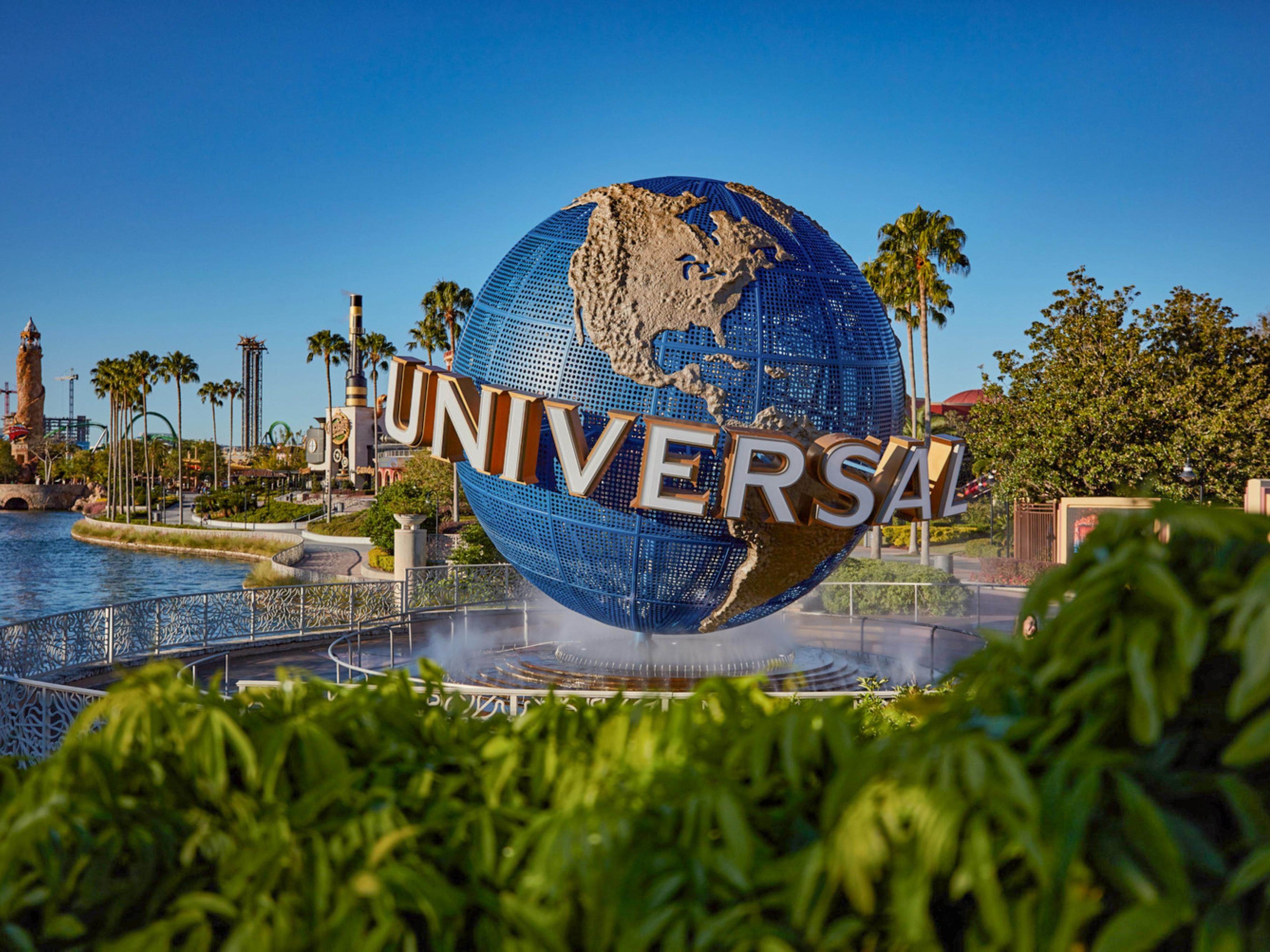 Universal Orlando sign surrounded by palm trees