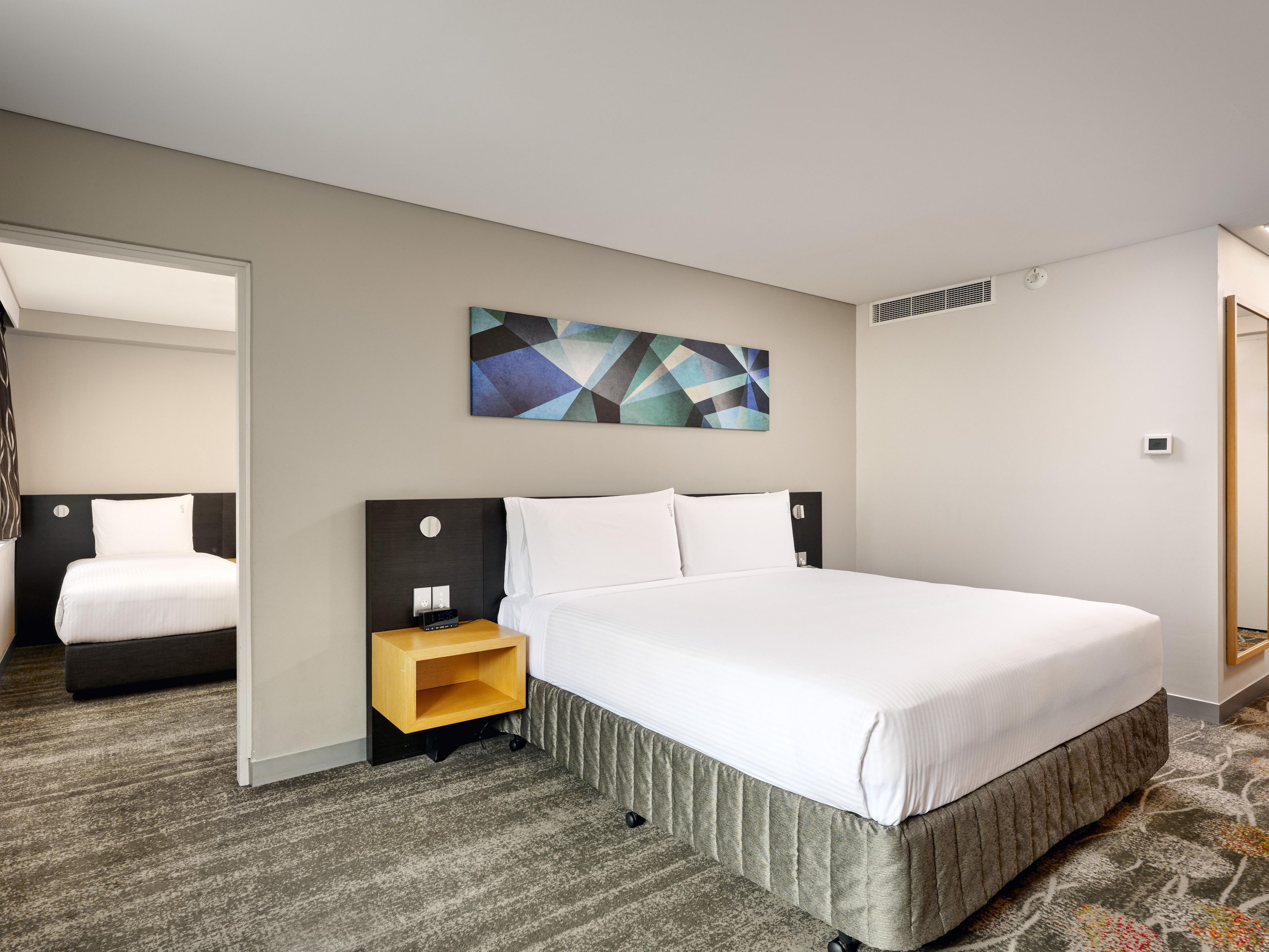 Our premium family rooms feature a king bed and a separate room with two single beds, providing space for everyone. A crib is available on request. Need more room? Connecting rooms offer the perfect solution for extra space, ensuring the whole family can relax comfortably.