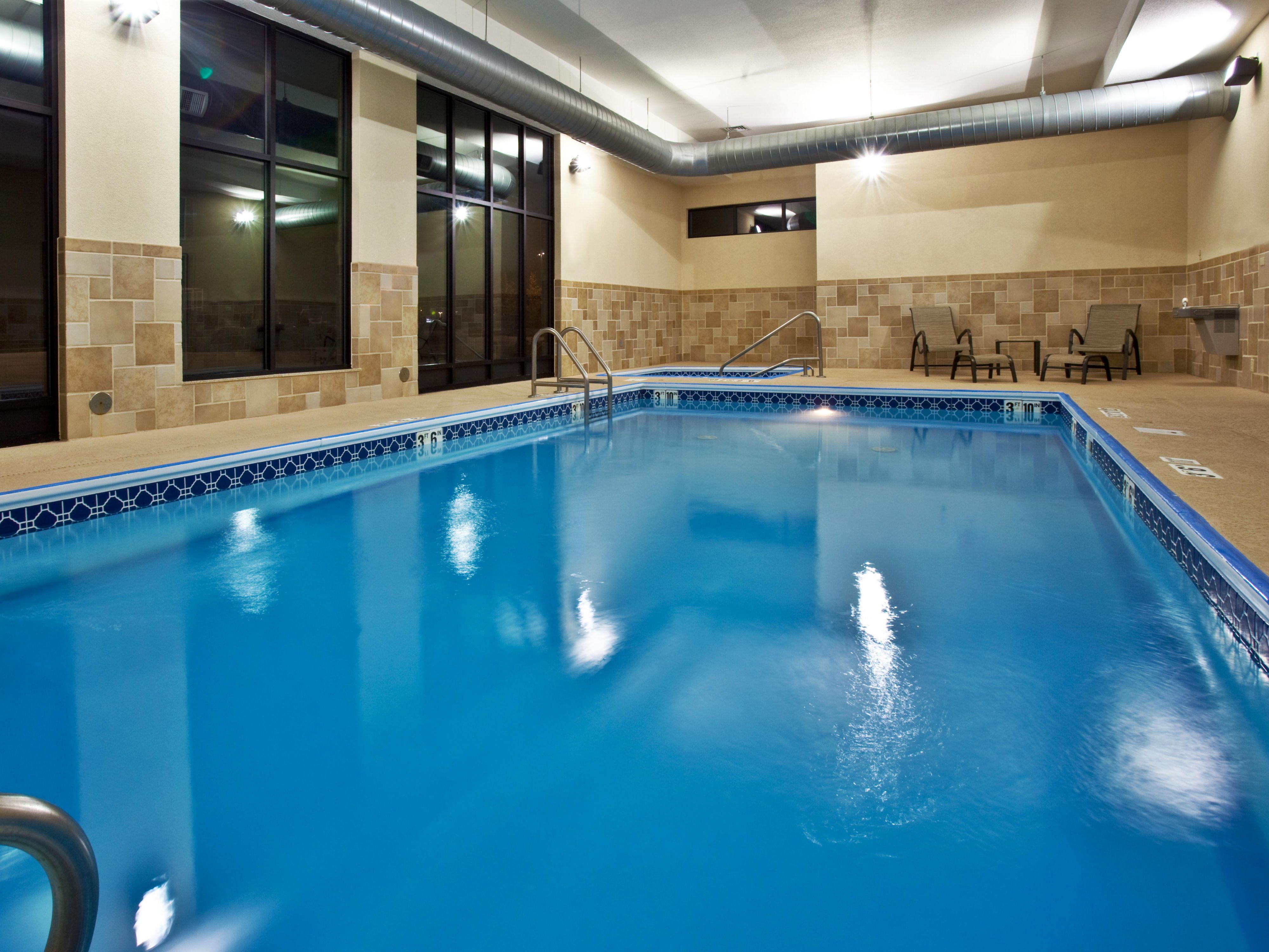 Pool area with hot tub.