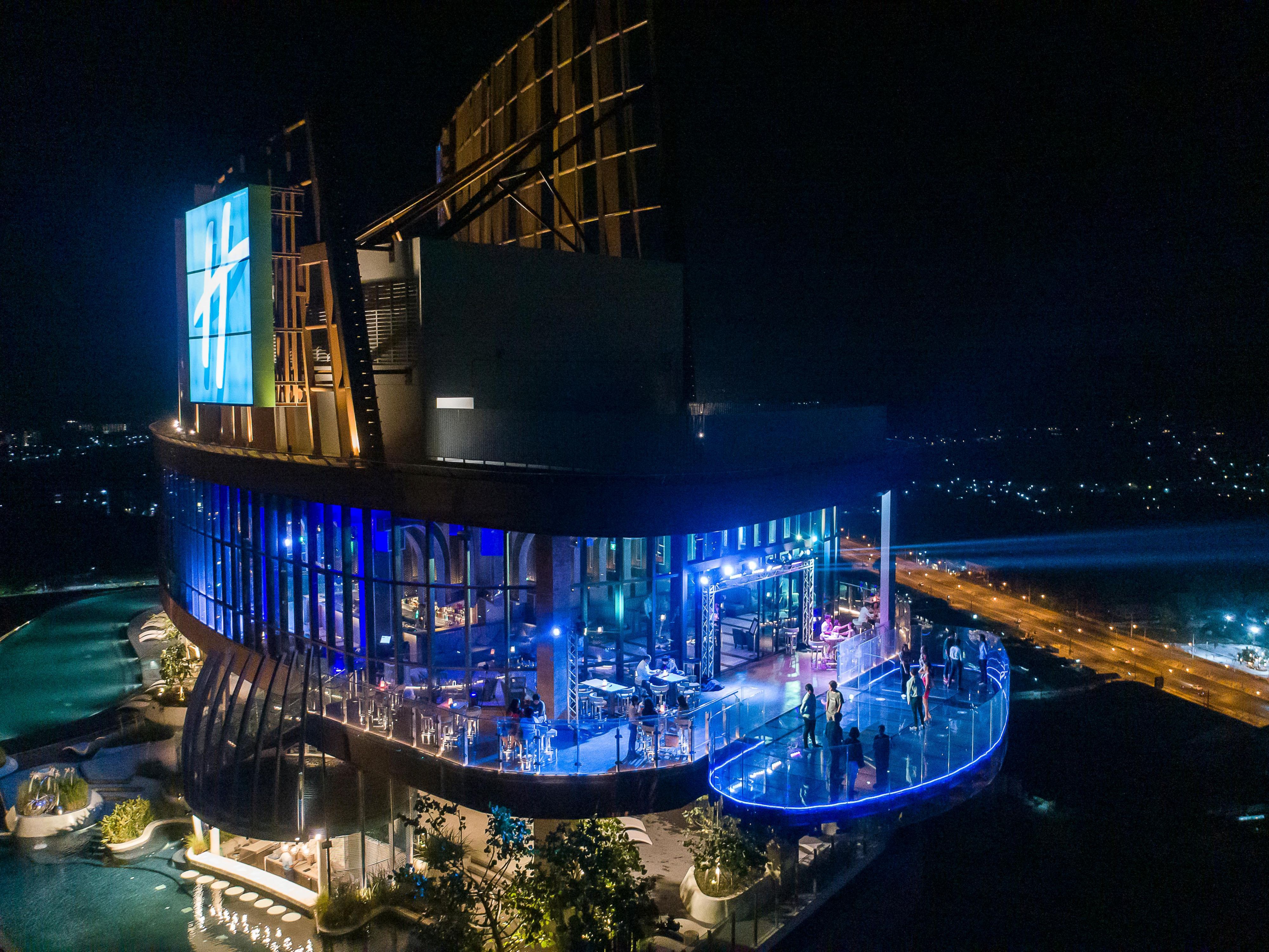 Drink designer cocktails in the comfortably chic Vana Nava Sky Bar and Sky Deck on Level 27 with the best views of Hua Hin.