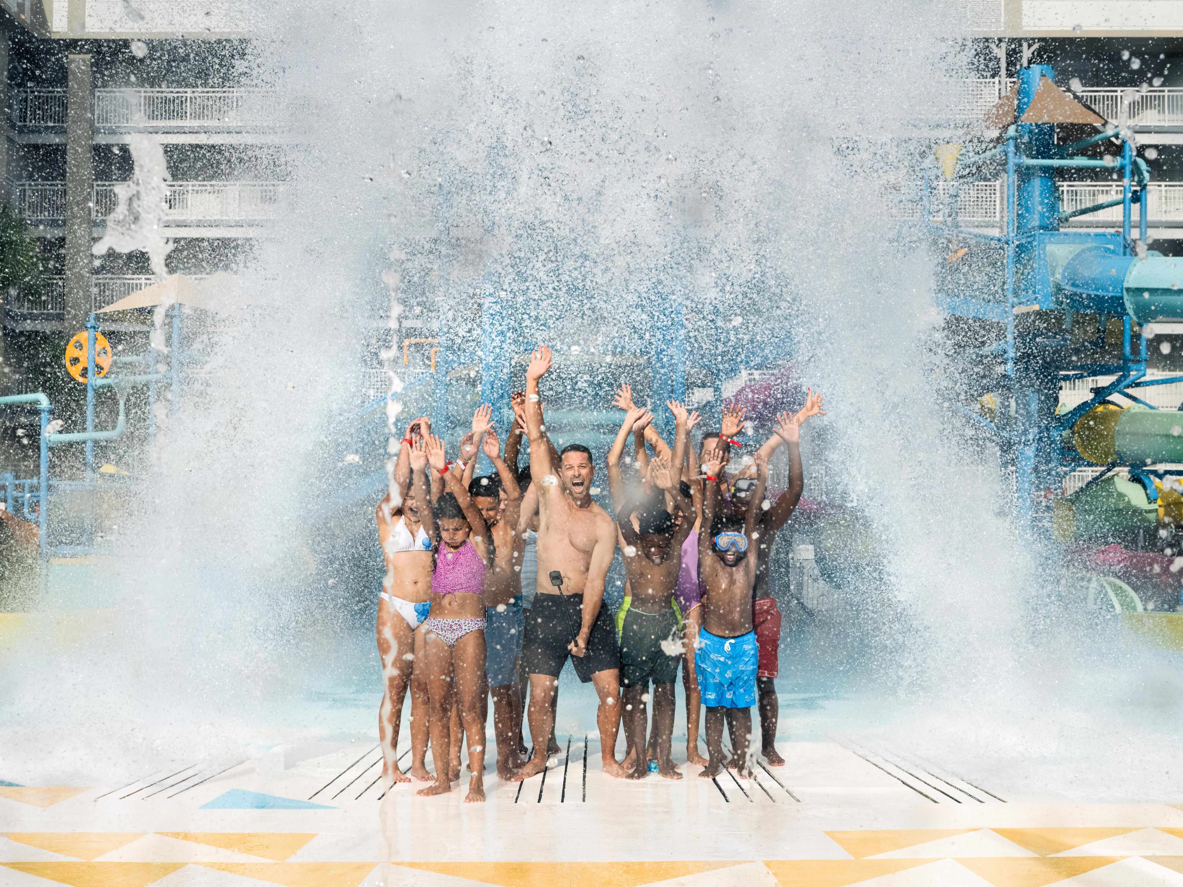 Guests standing under the splash zone at the waterpark
