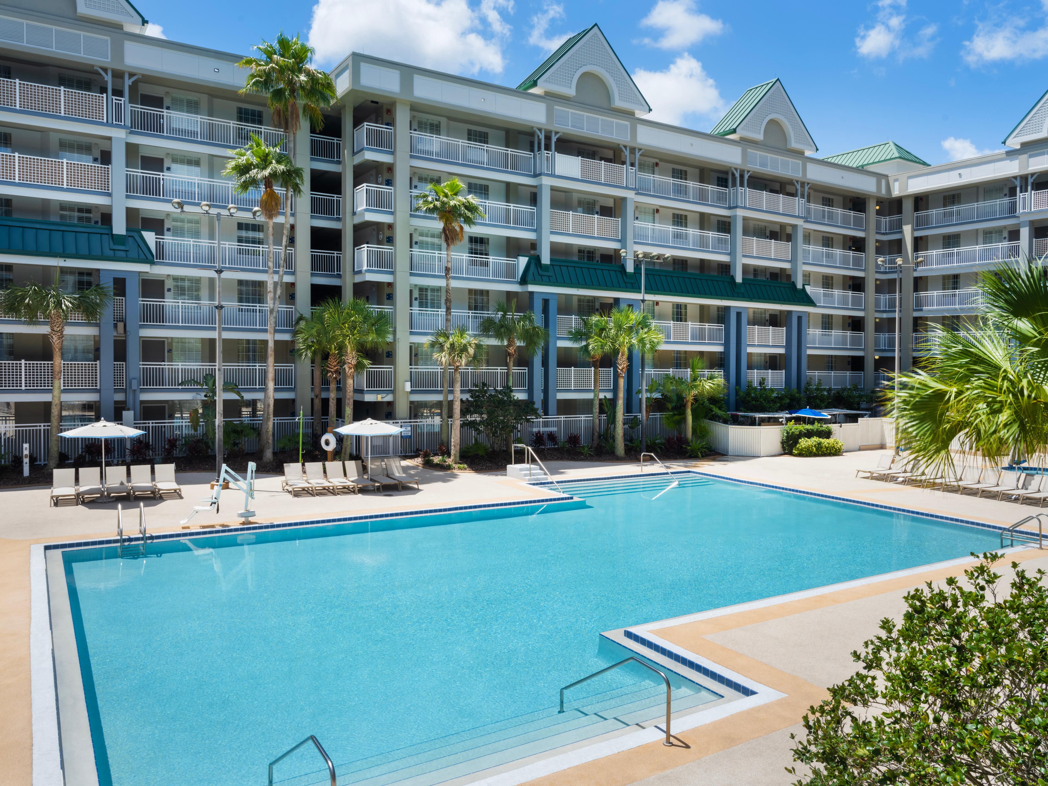 Oasis pool with chairs and umbrellas