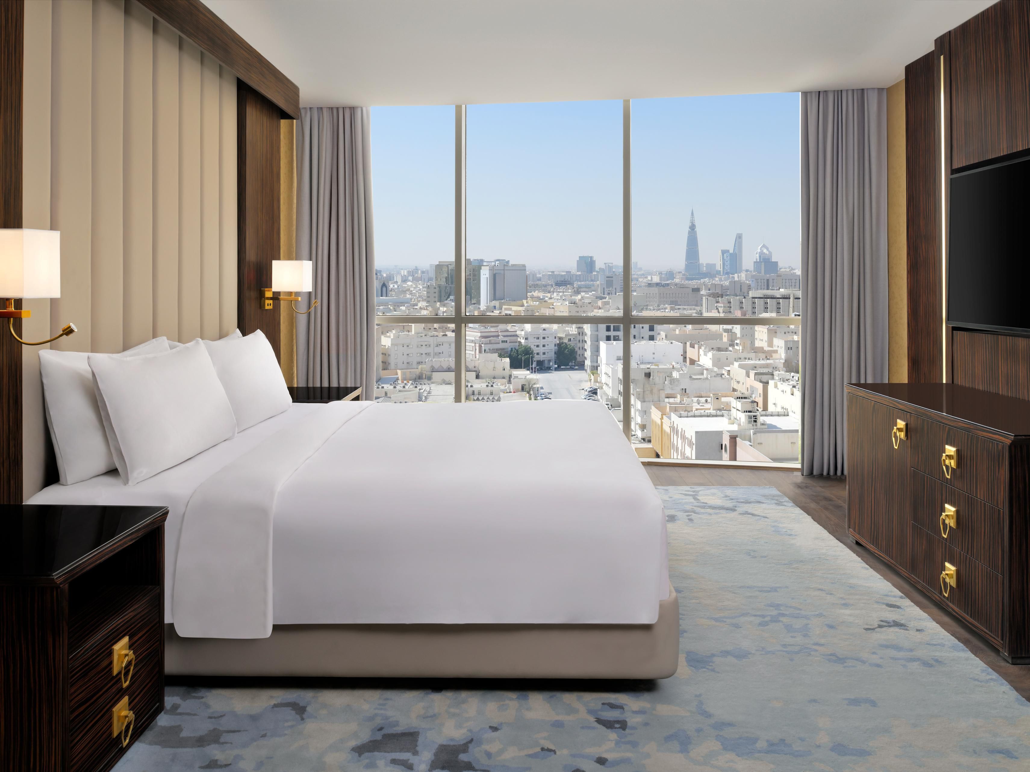Step into our one-bedroom suite, thoughtfully designed for ultimate comfort. Enjoy panoramic downtown views, a welcoming and cozy living area, a fully-equipped kitchenette, and a jetted bathtub. Experience the perfect blend of style and functionality for an unforgettable stay that caters to all your needs.
