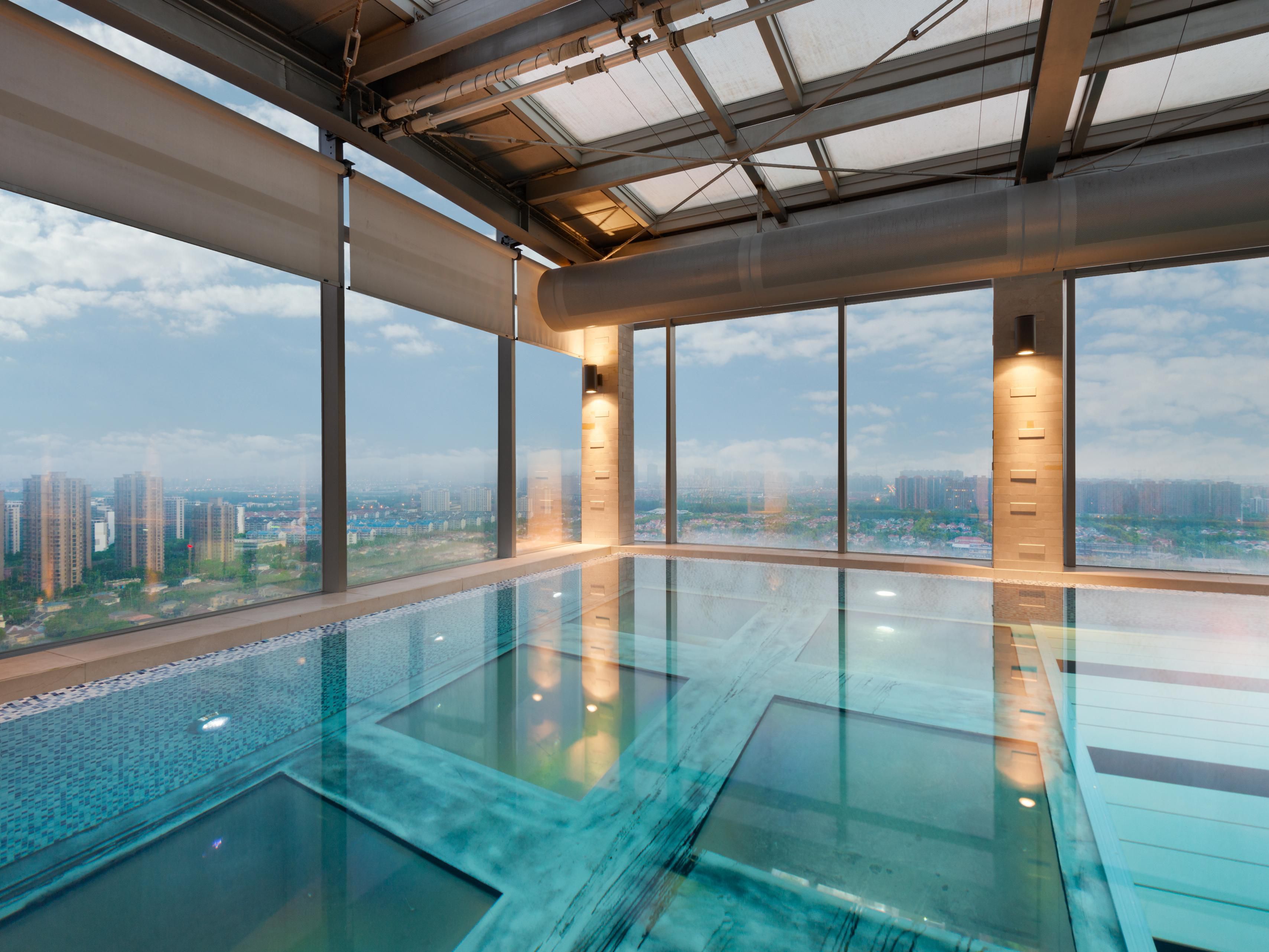 Located on the 24F of the hotel, nearly 100 meters above the ground,  Portions of the pool's structure extend gracefully beyond the main building, while its bottom is made of fully transparent material, making swimmers feel as if they are in the clouds. Through the clear bottom, the urban streetscape can be seen at a glance, with nothing missed.