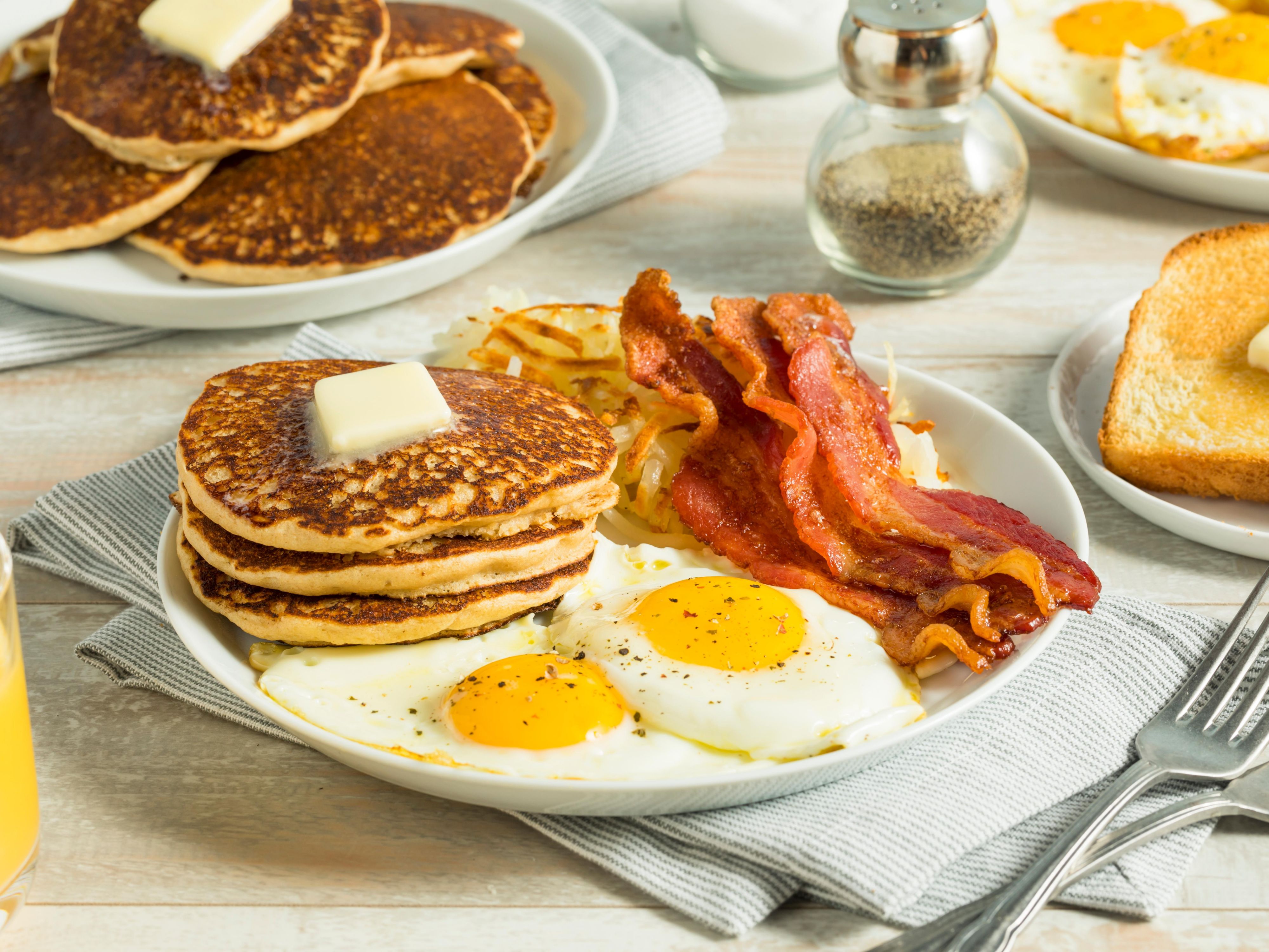 Breakfast plate with pancakes, bacon and eggs