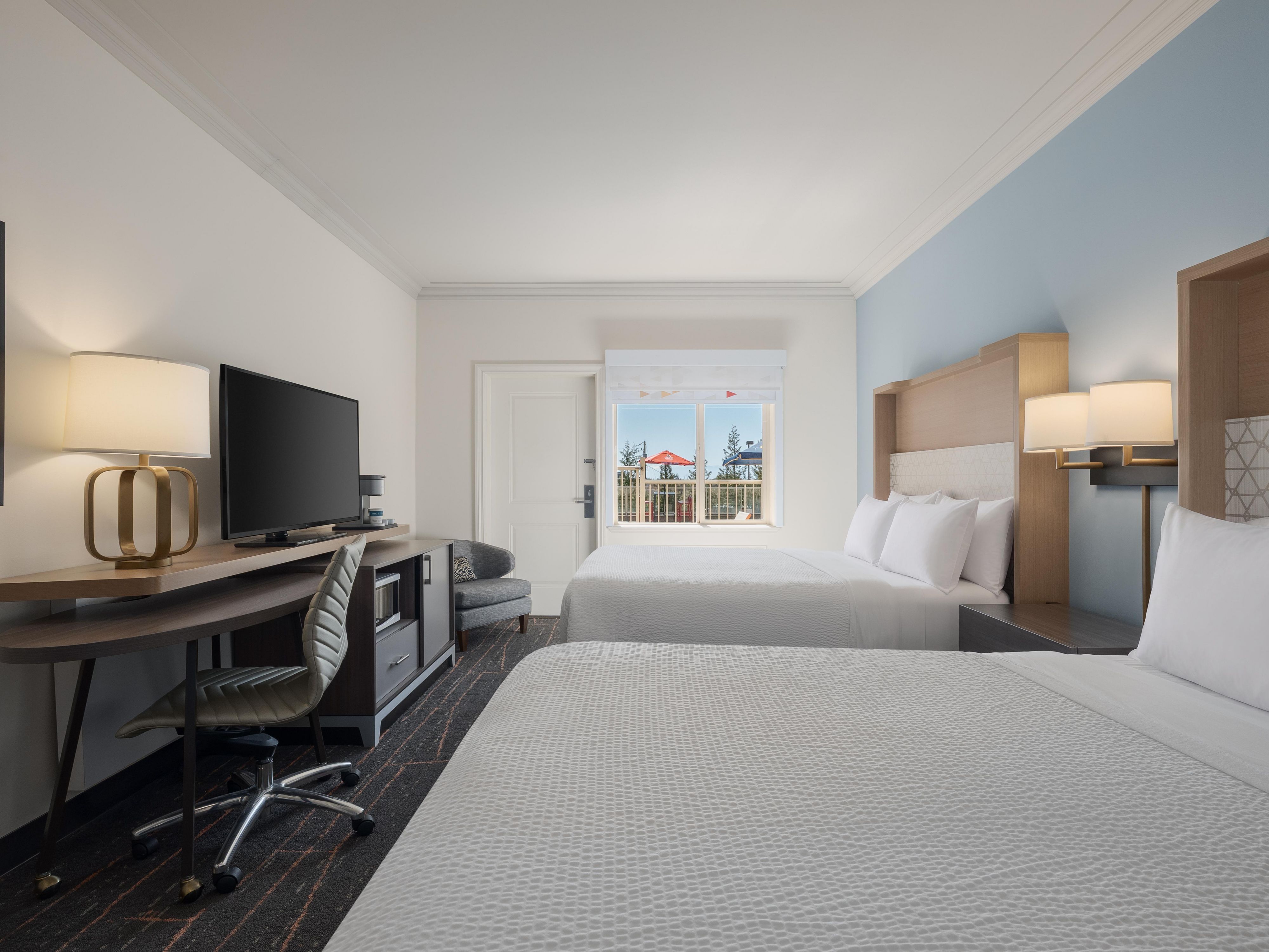 Guest room with two queen beds and pool view