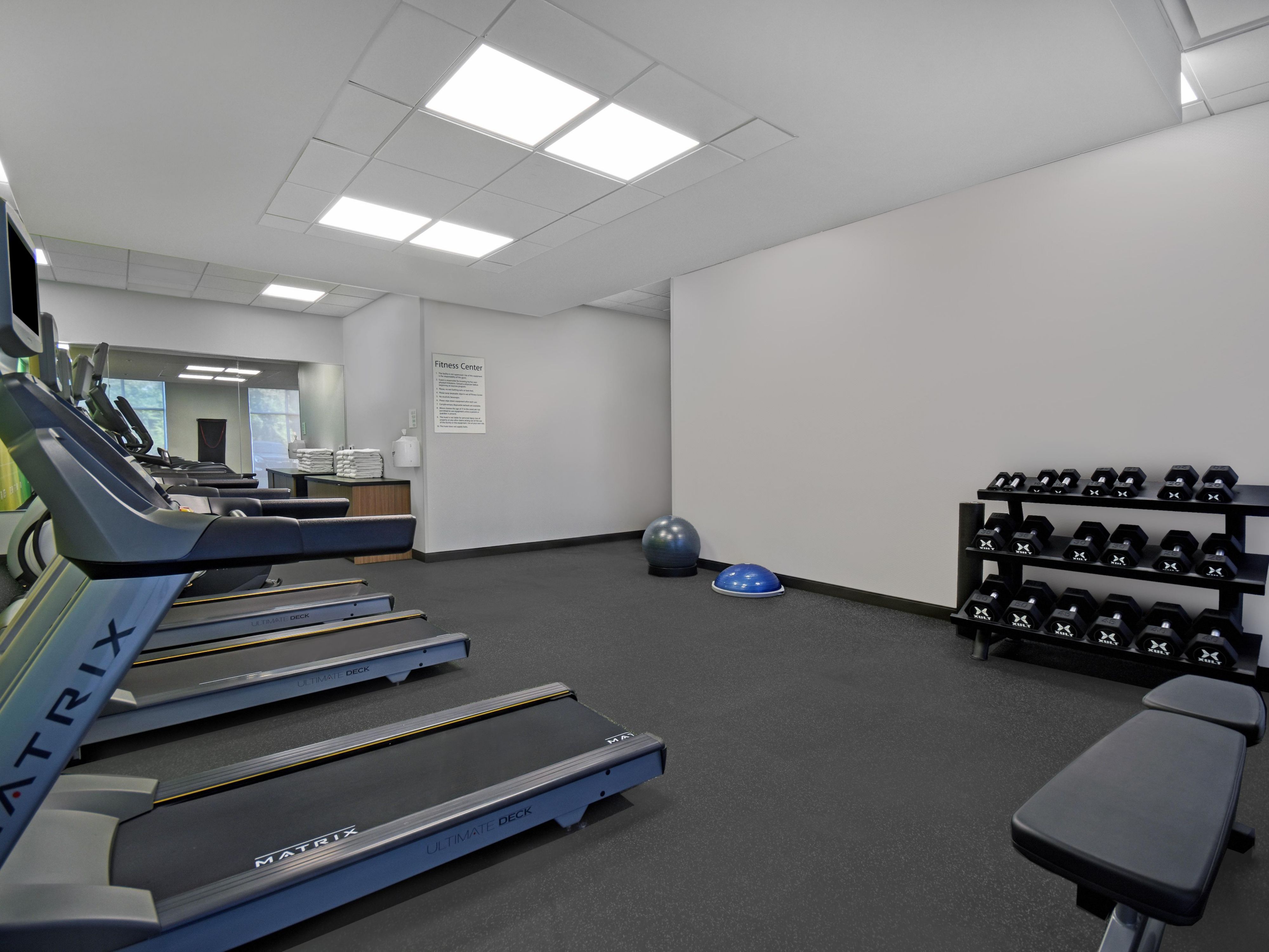 Keep up with your workout routine in our fitness room equipped with treadmills, elliptical machines, and free weights.