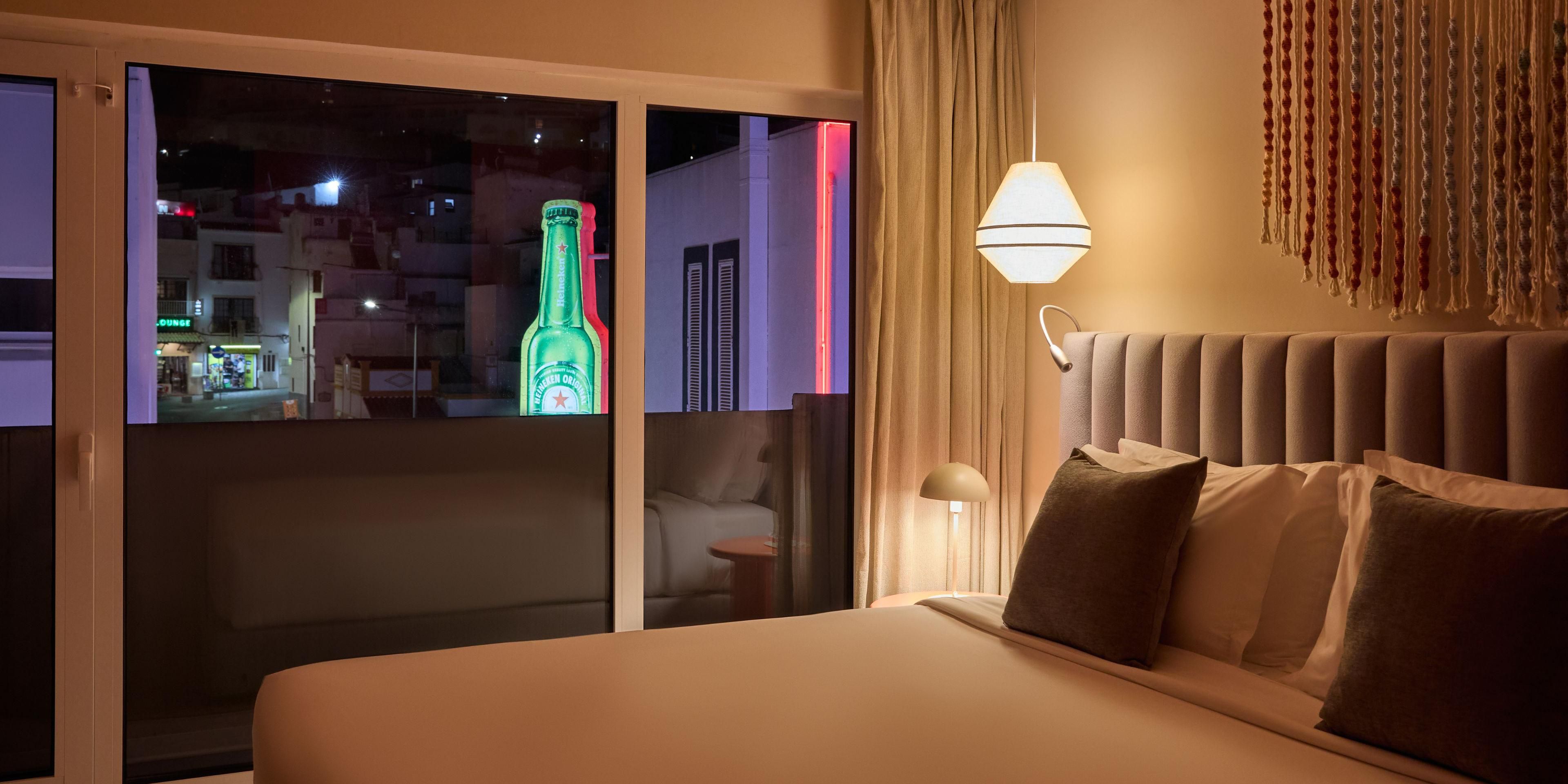 Feel the city pulse from your nightlife-facing room