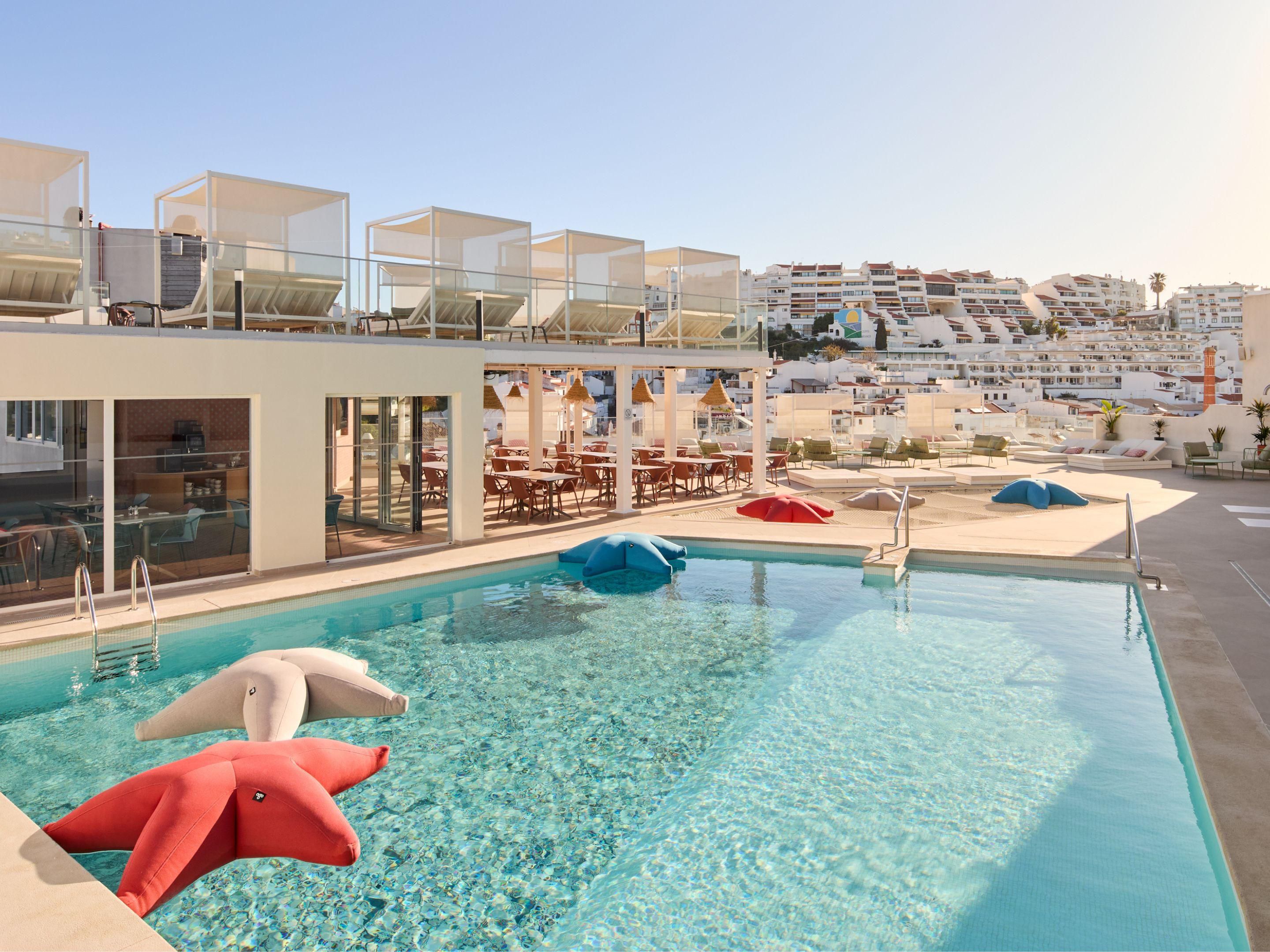 Take a dip in the outdoor pool at the Hotel Indigo Albufeira.