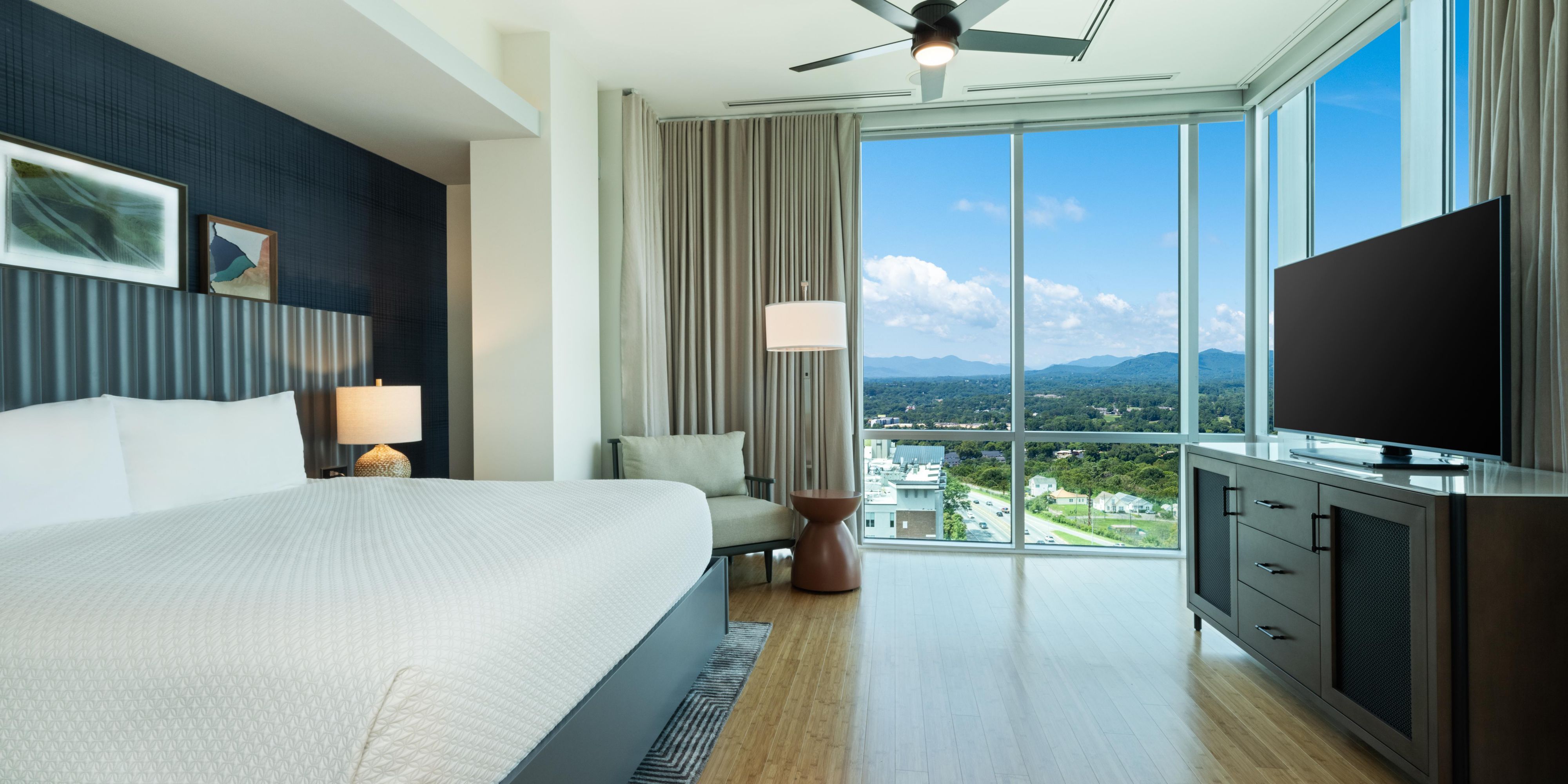 Condo guest bedroom with king bed and sweeping views of Asheville