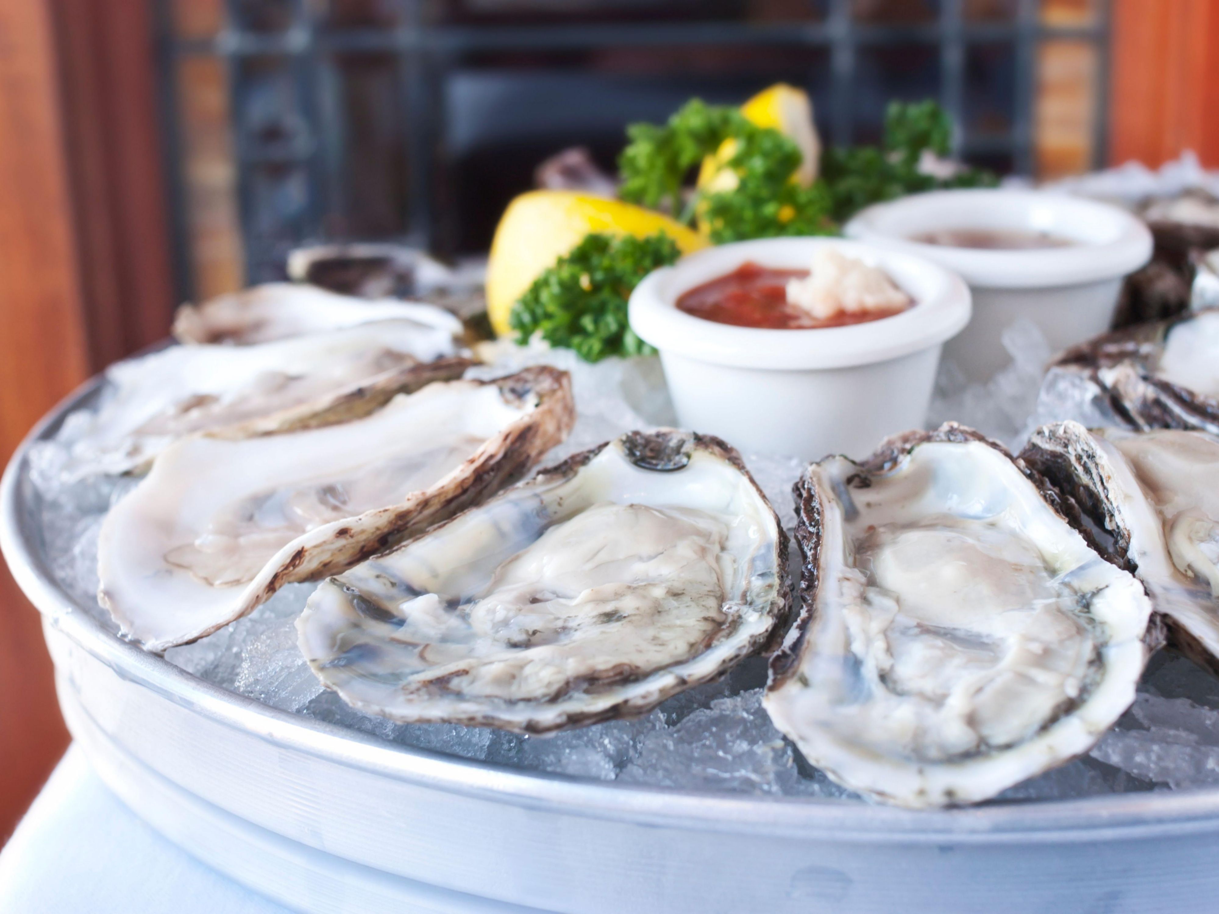 A platter of fresh oysters on the half shell.