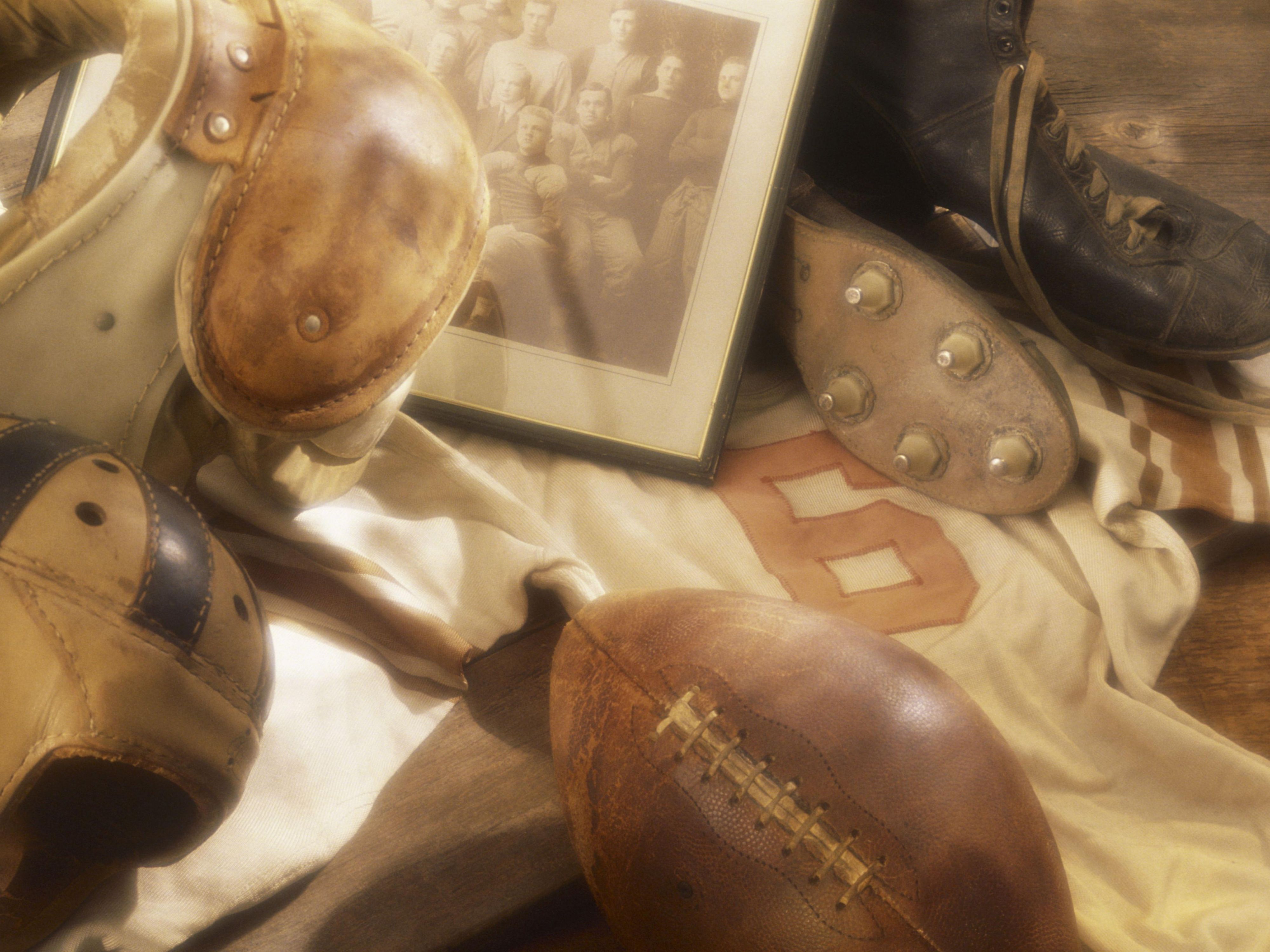 Vintage football gear, helmet, ball, and an old photo. 