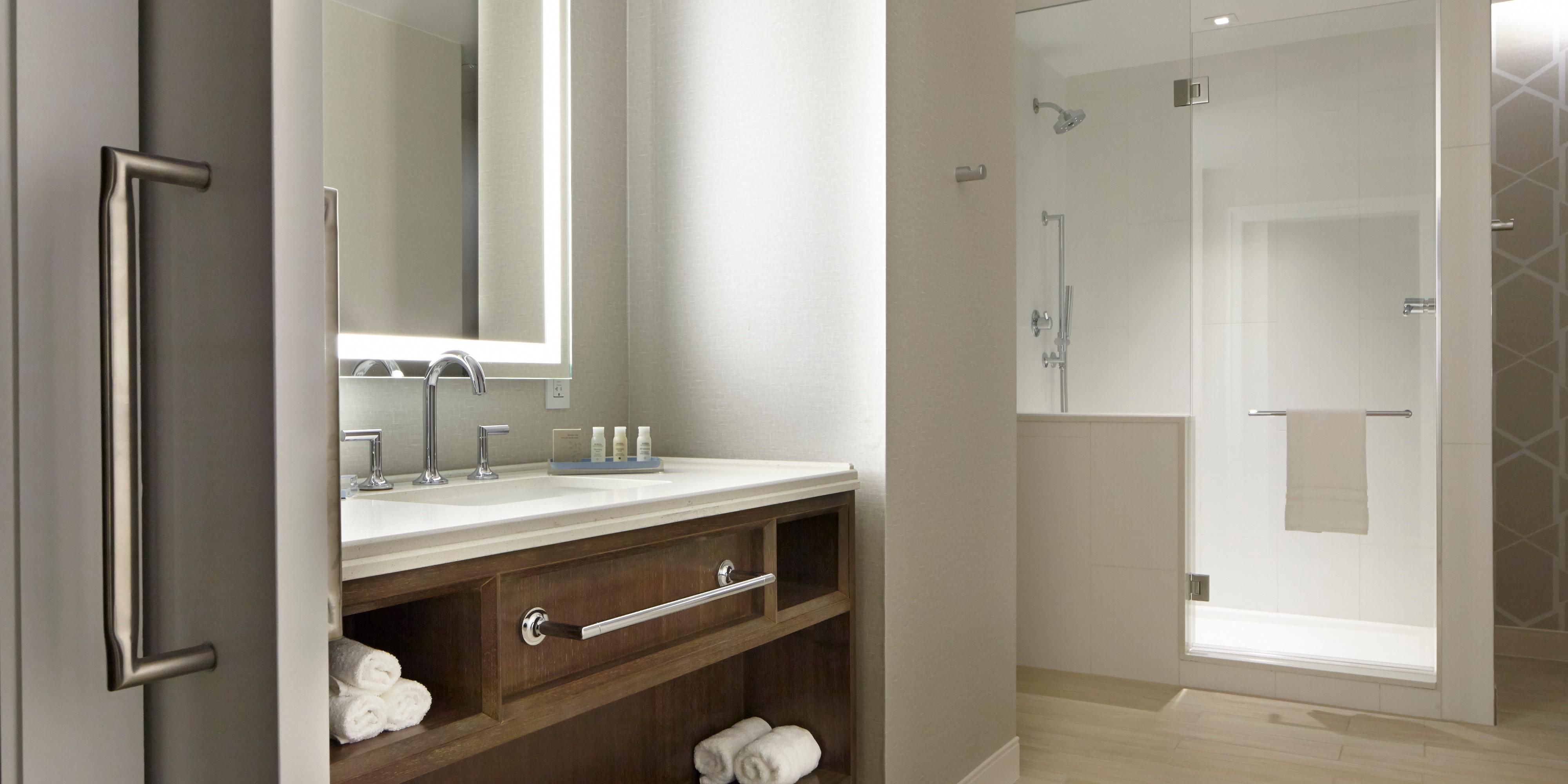Clean and cozy guest bathroom with ample space to prepare. 