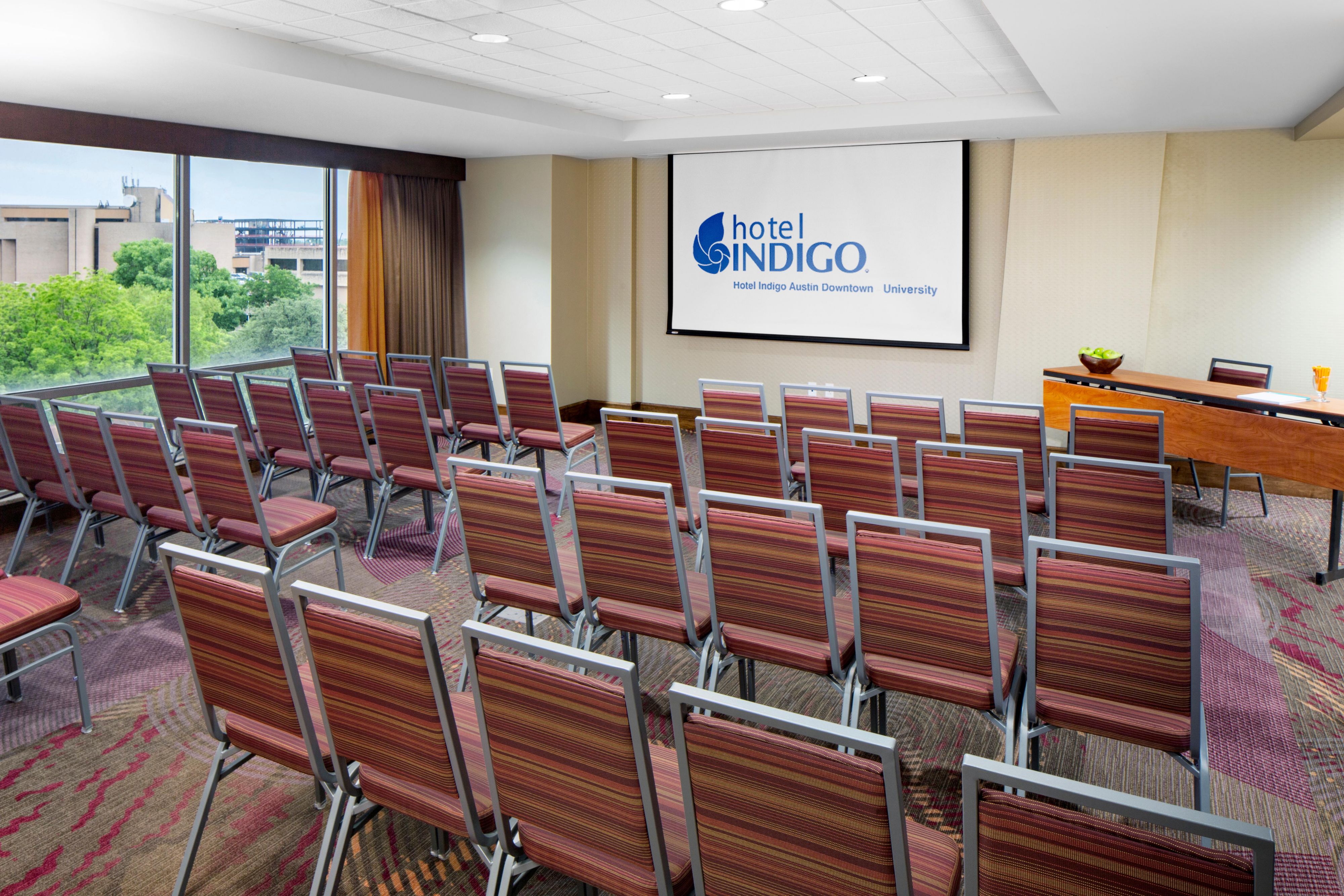 meeting room with rows of chairs set up for a meeting 