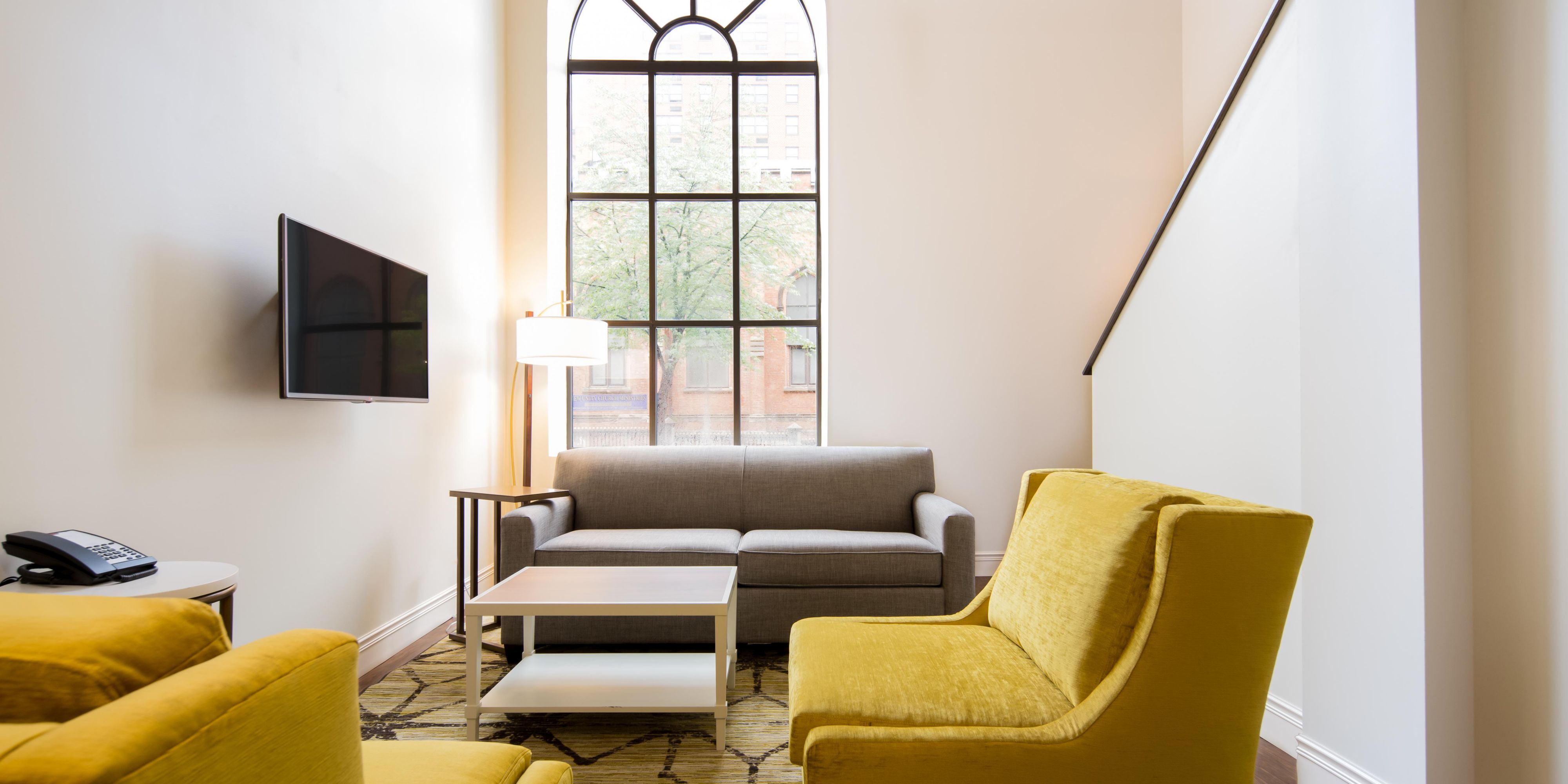 Relax in a sunlit hotel room with loft-style layout in Baltimore.