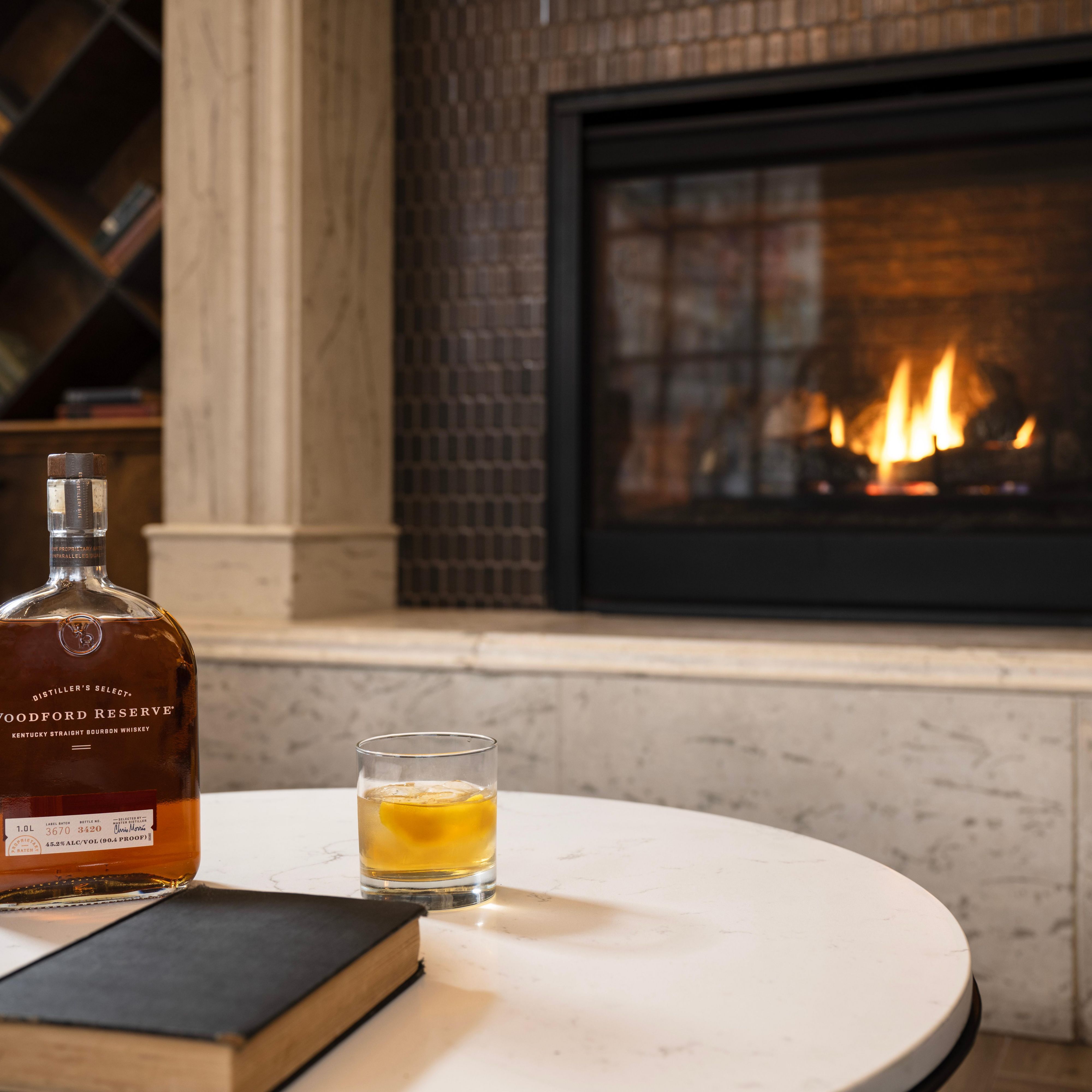 Whiskey on the rocks by a fire 