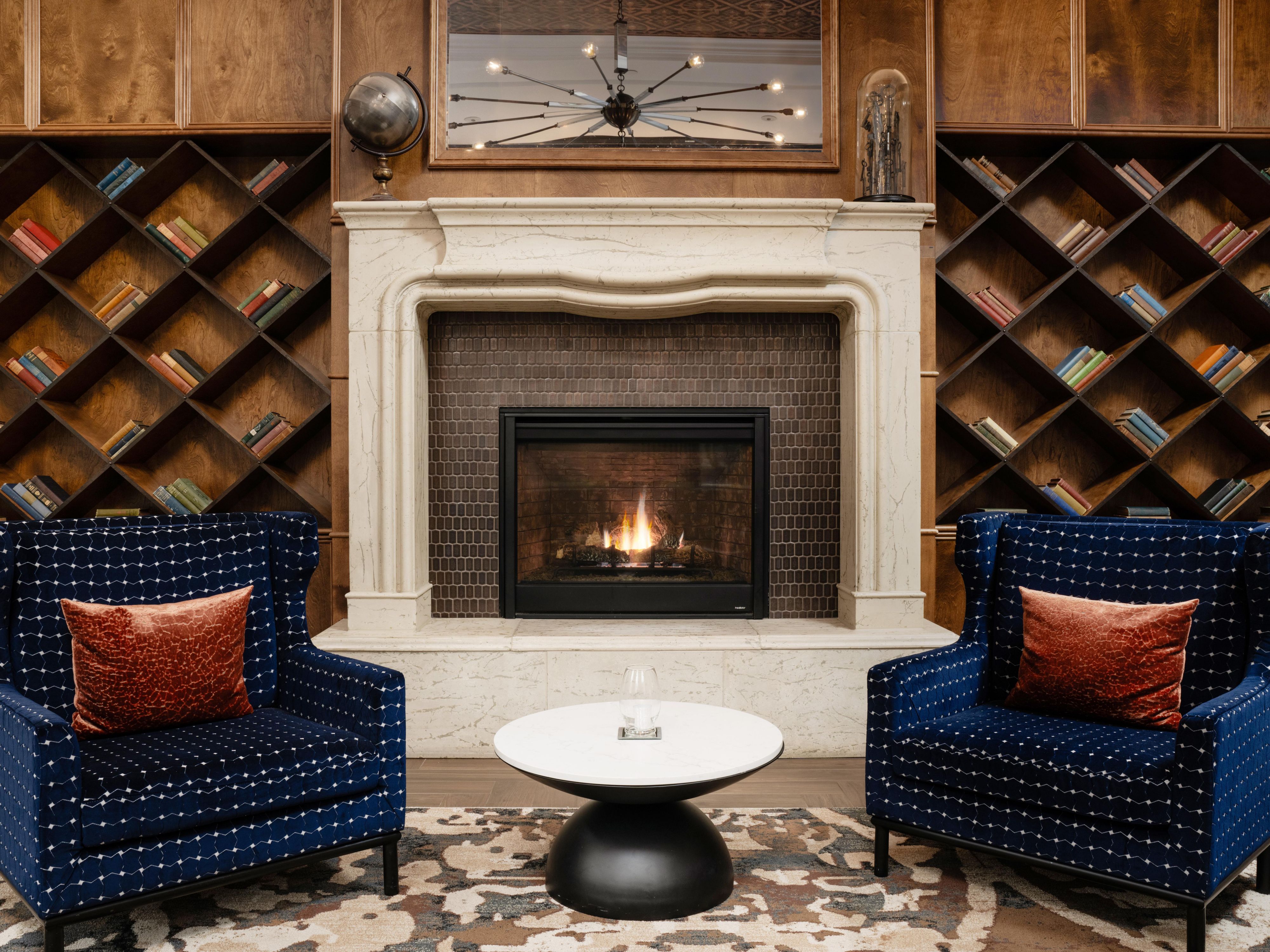 Unwind by the fire in our cozy library.