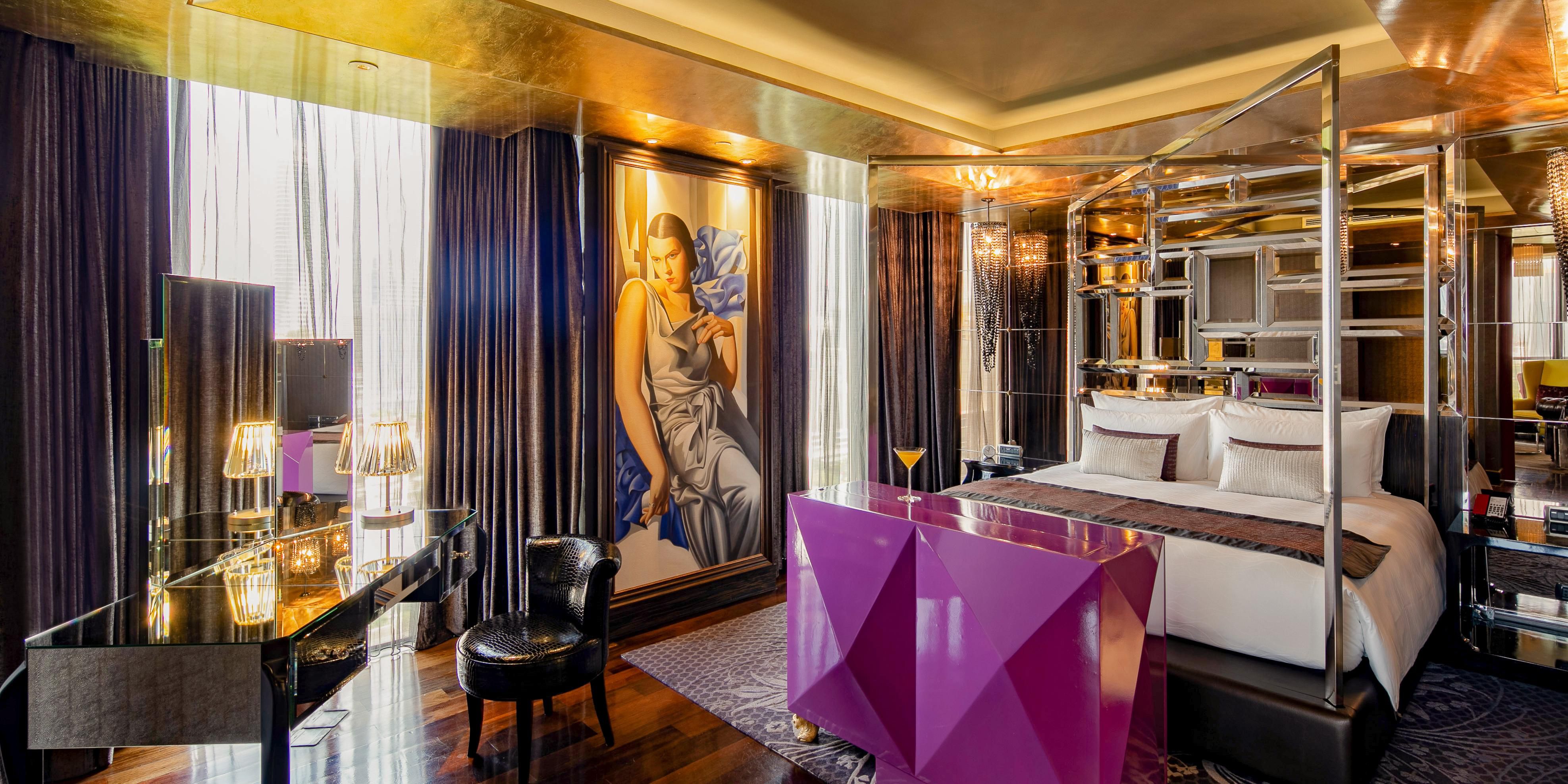 The bedroom of the one bedroom suite is a glam affair.