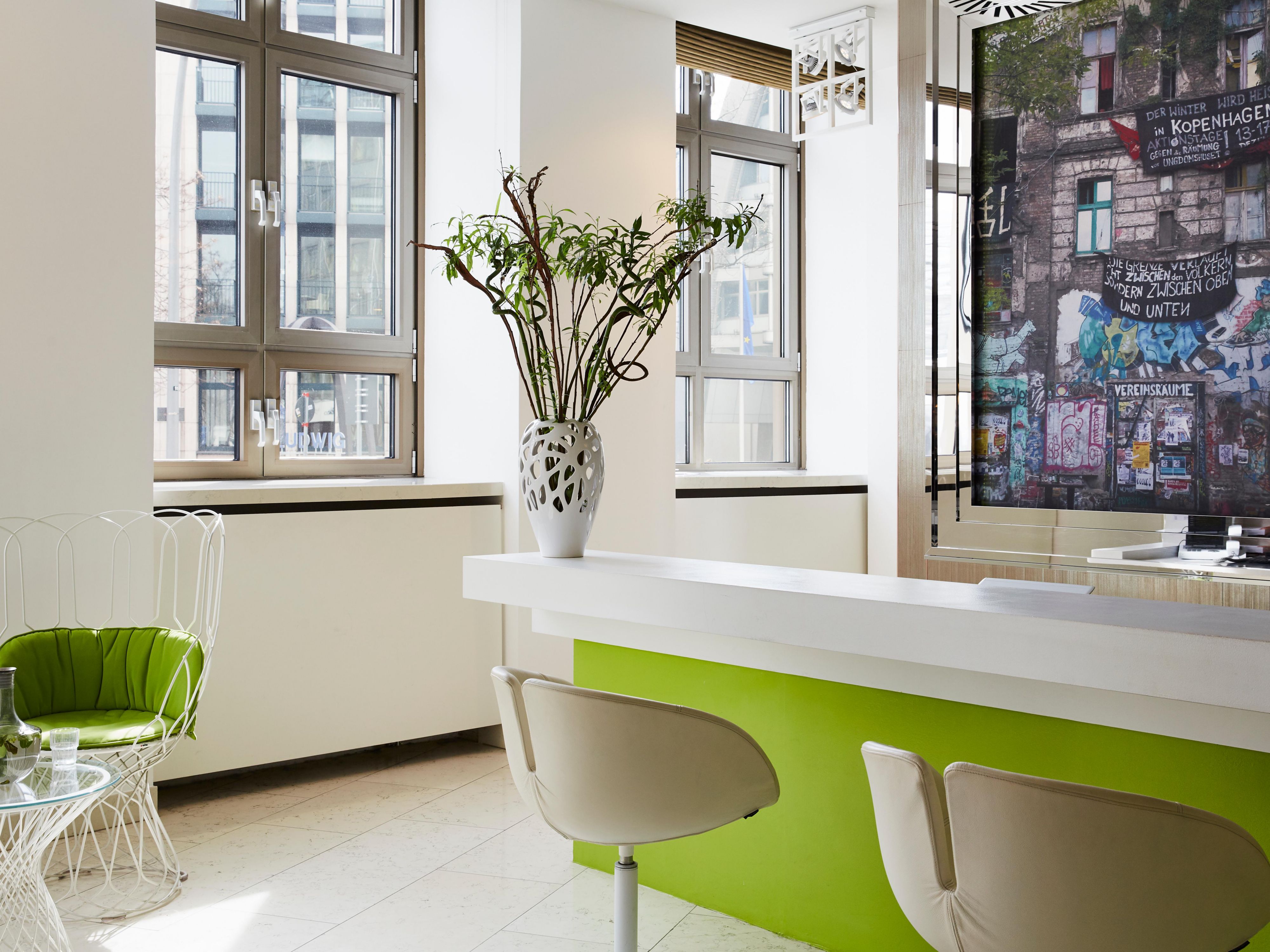 The bright Hotel Indigo lobby with Berlin street art images.