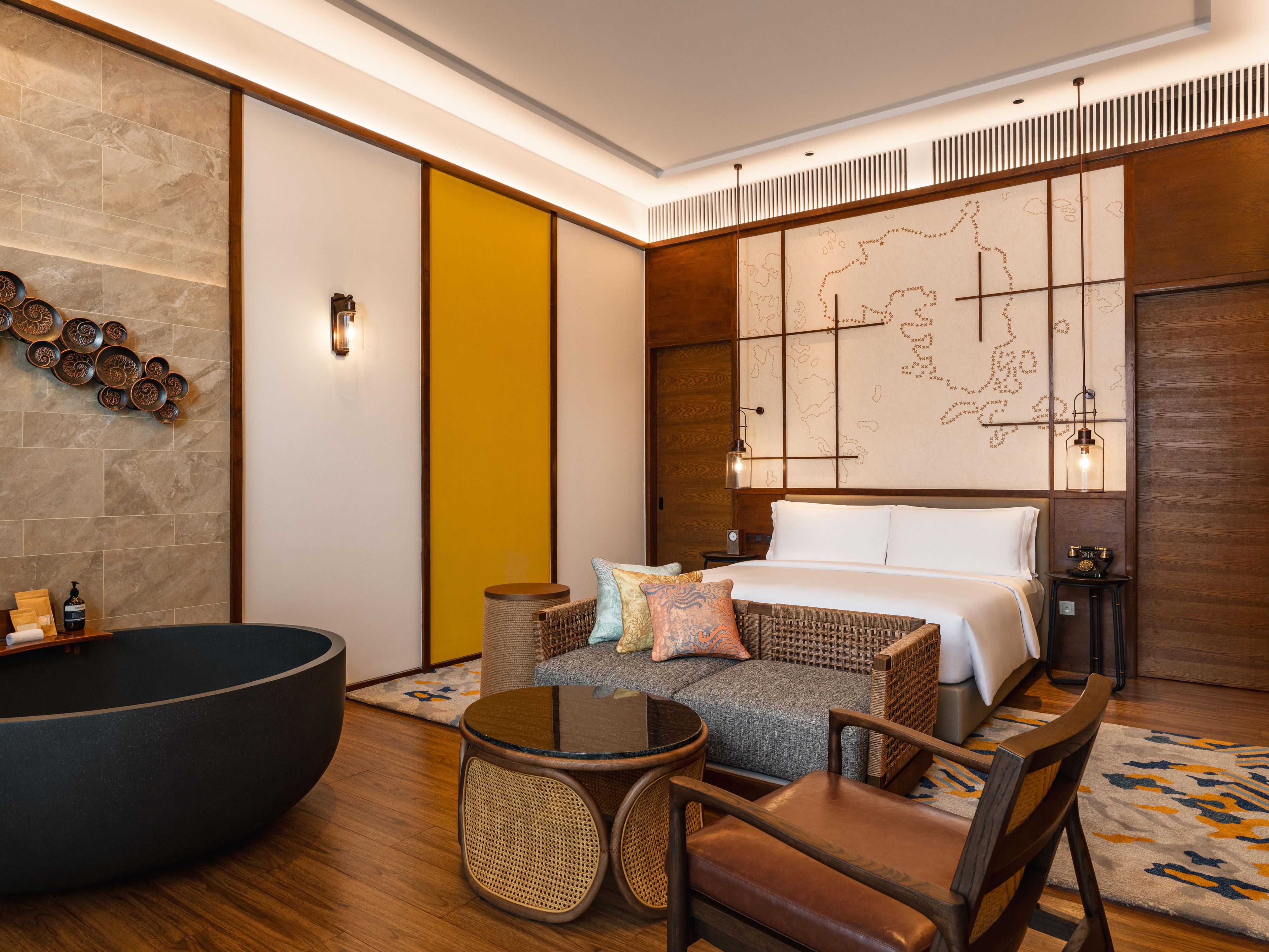 Indoor bathtub in a one bedroom suite with Bintan folklore