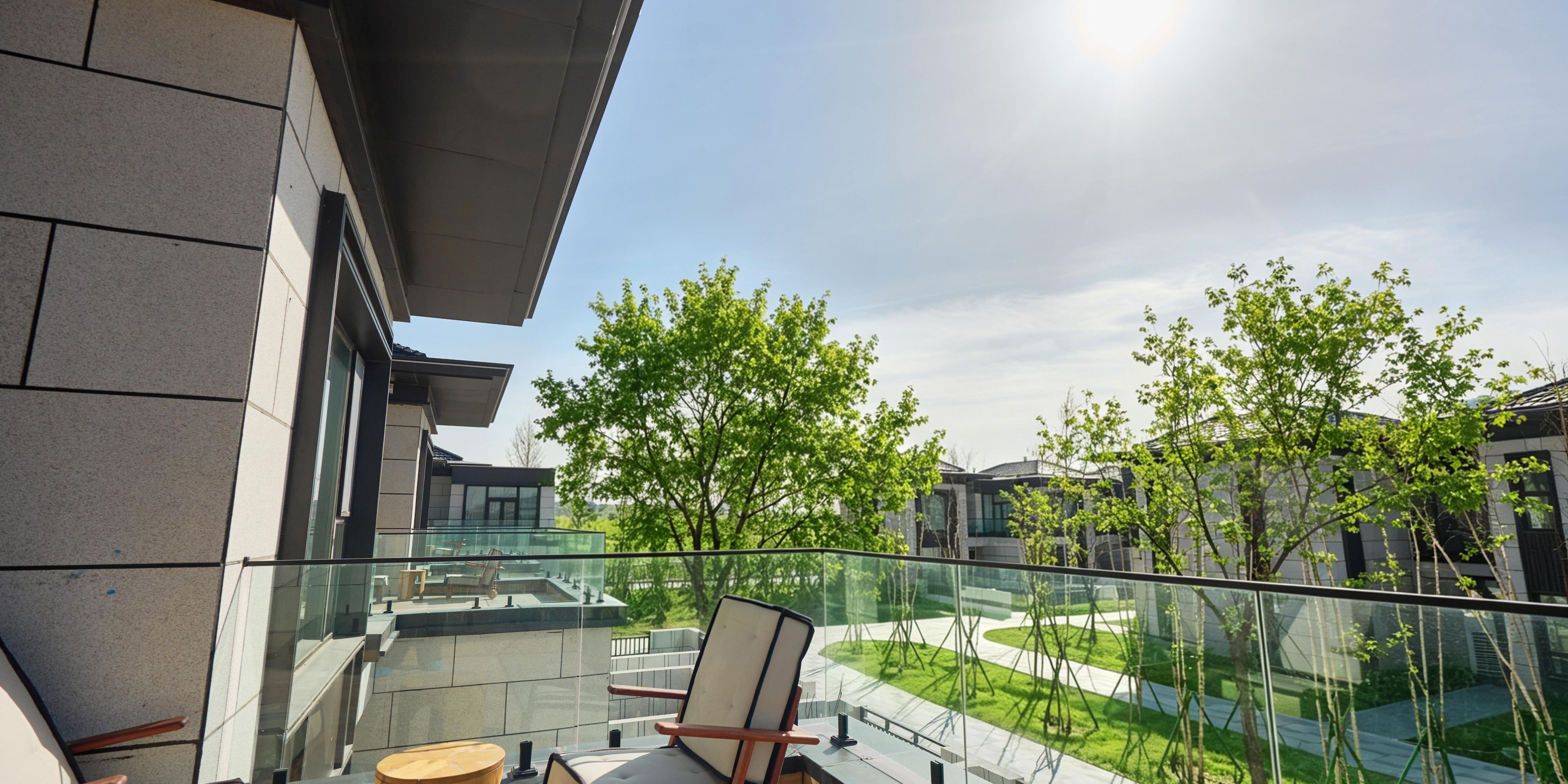 A private terrace overlooks the hotel garden landscape.