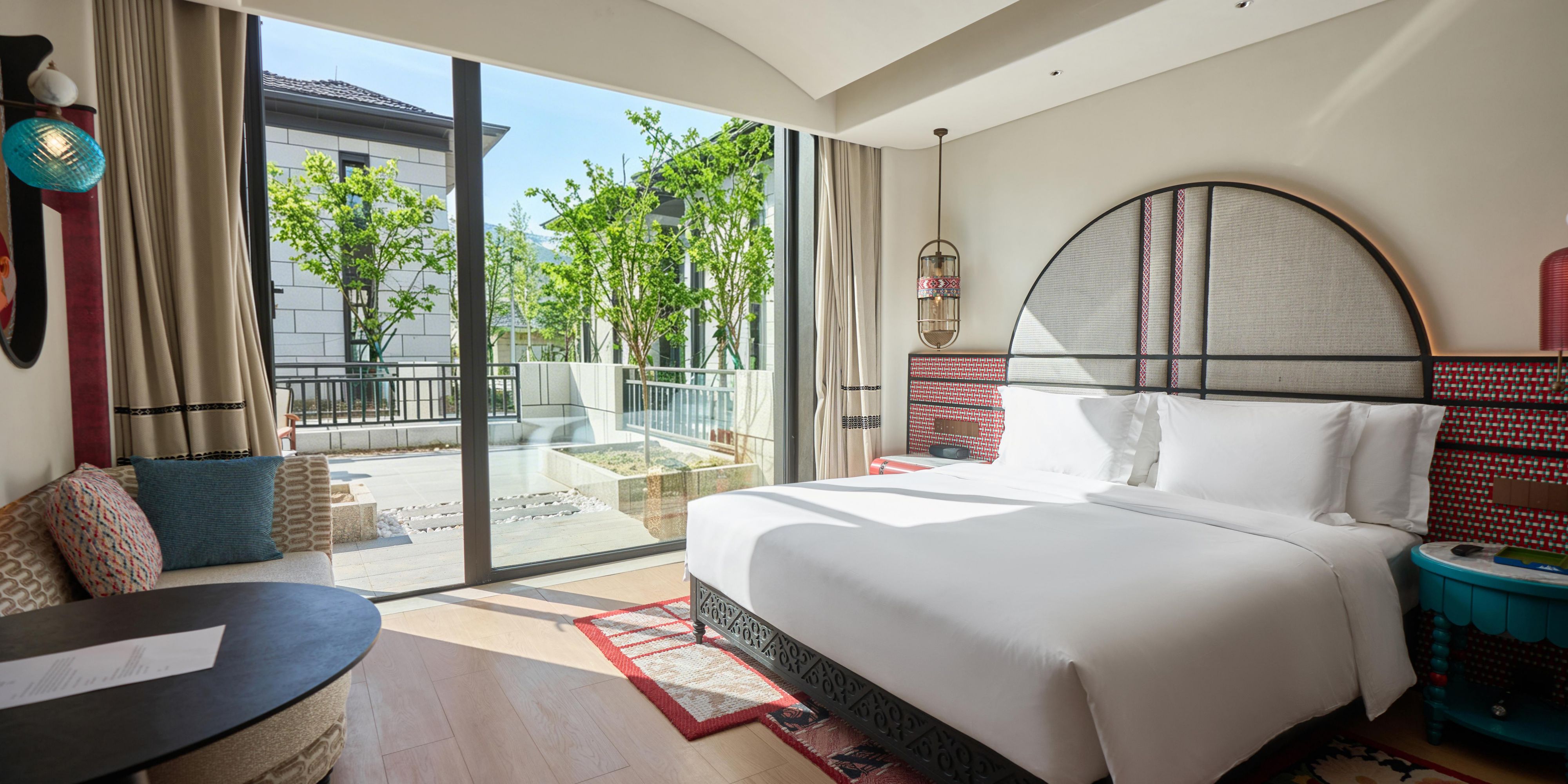 Garden view through floor-to-ceiling windows, courtyard access