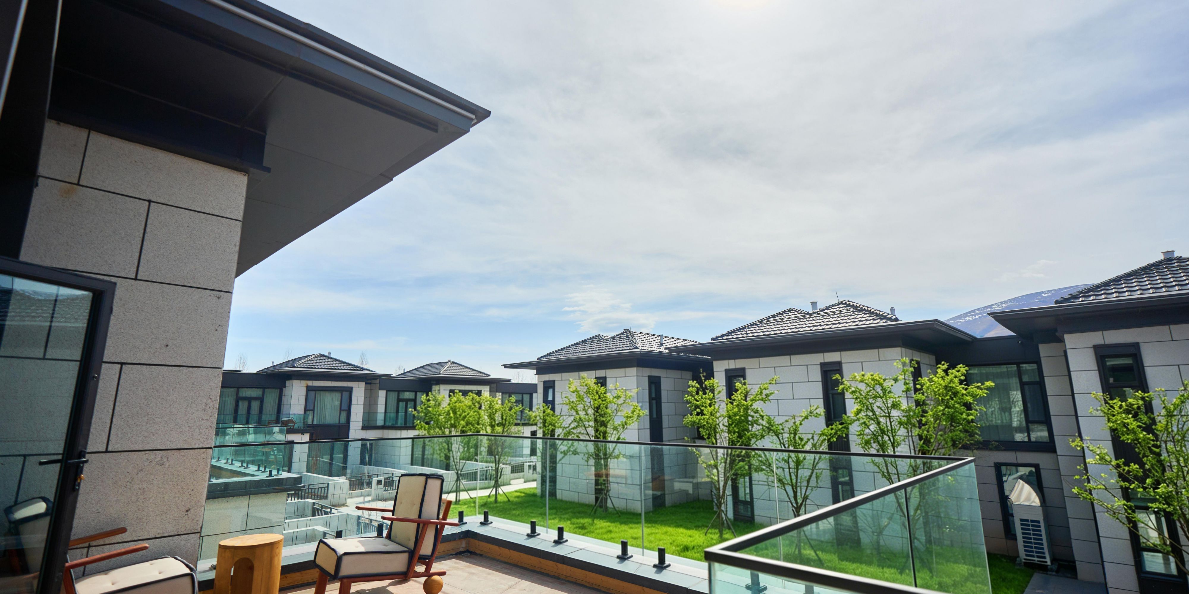 A private terrace overlooks the hotel garden landscape.