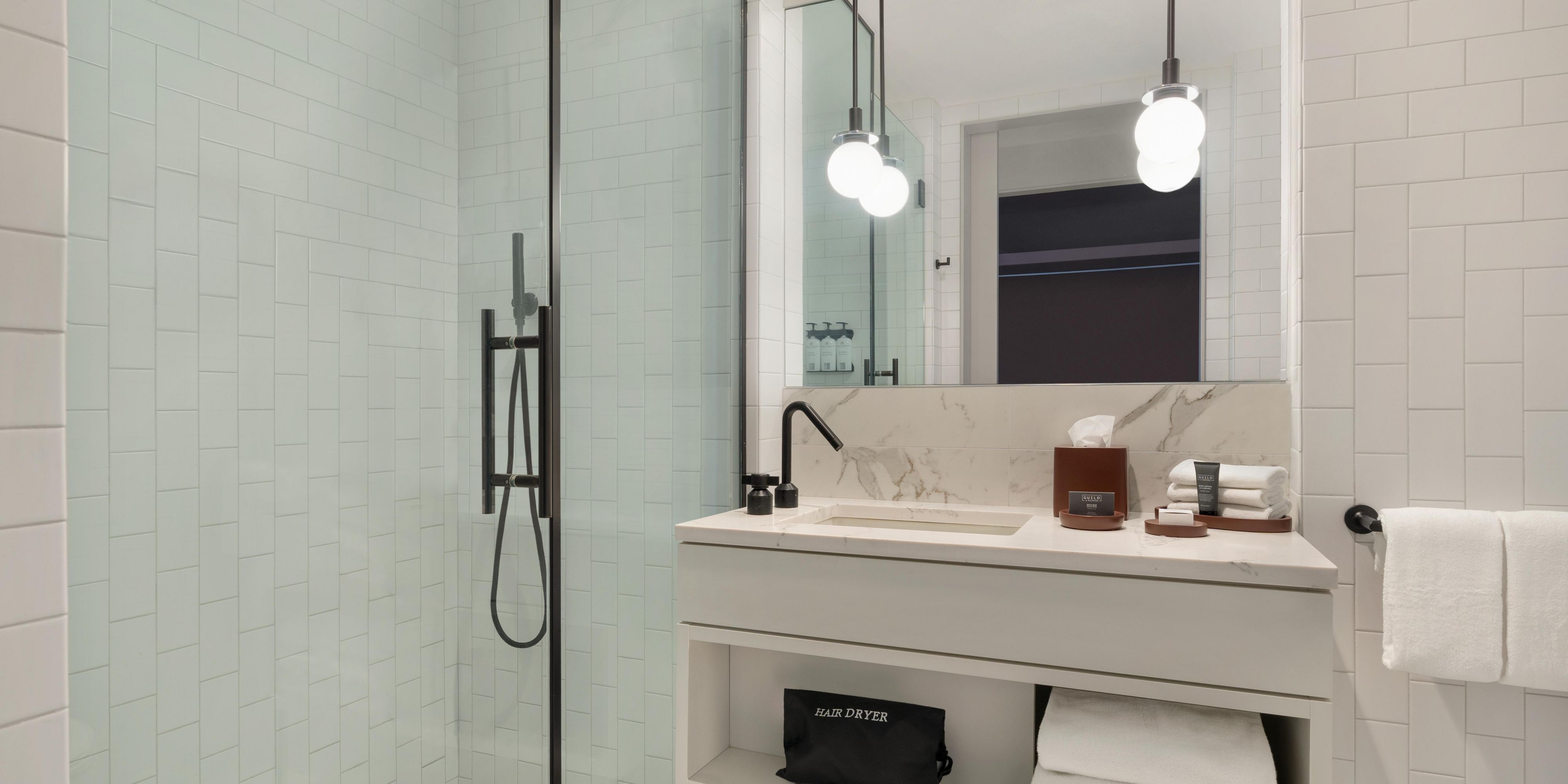 Sleek and modern bathrooms with rain shower head.