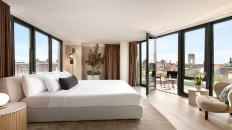Guest room with floor to celing windows and veranda