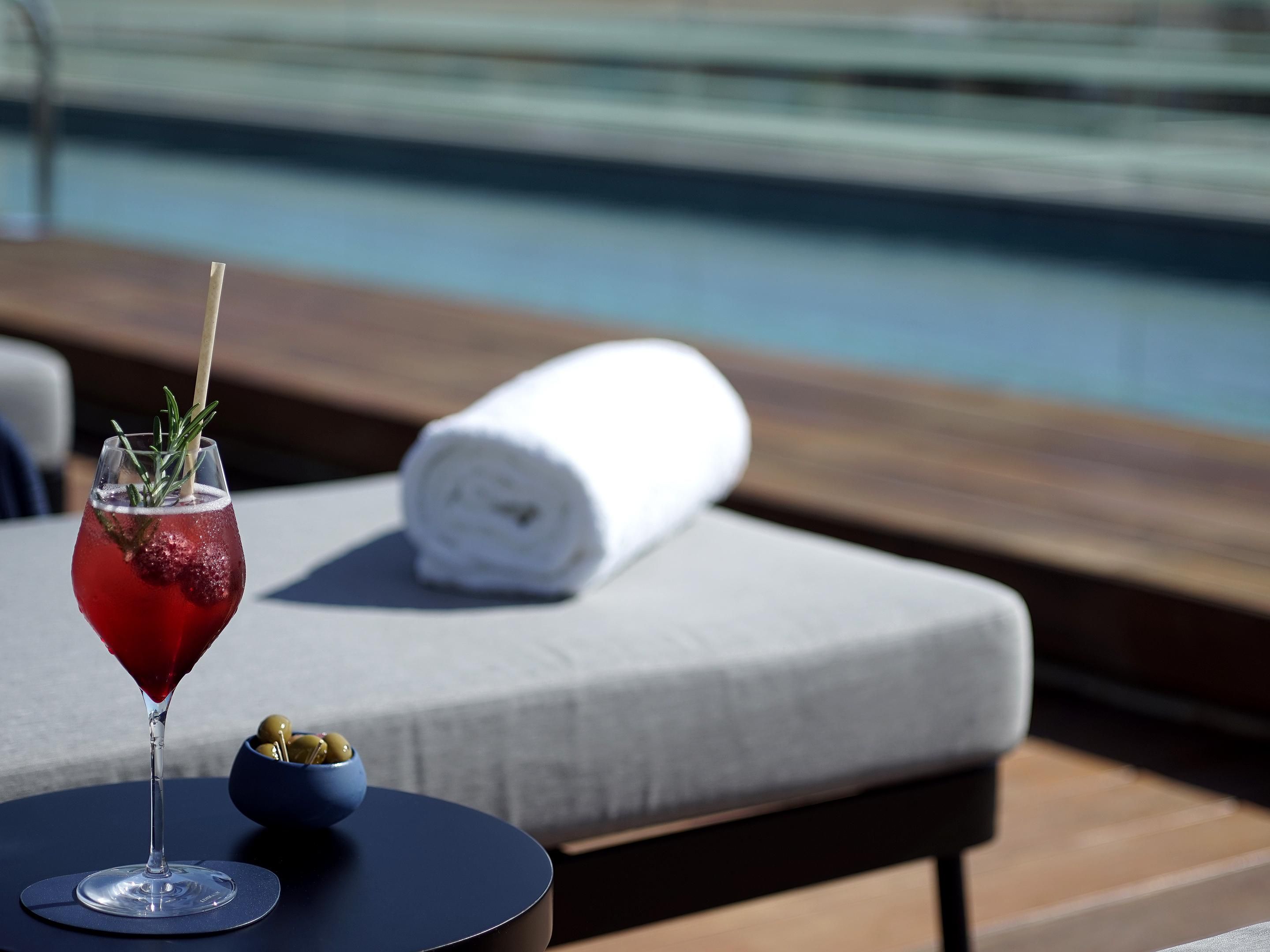 Enjoy Cosmopolitain cocktail at the swimming pool on the rooftop.