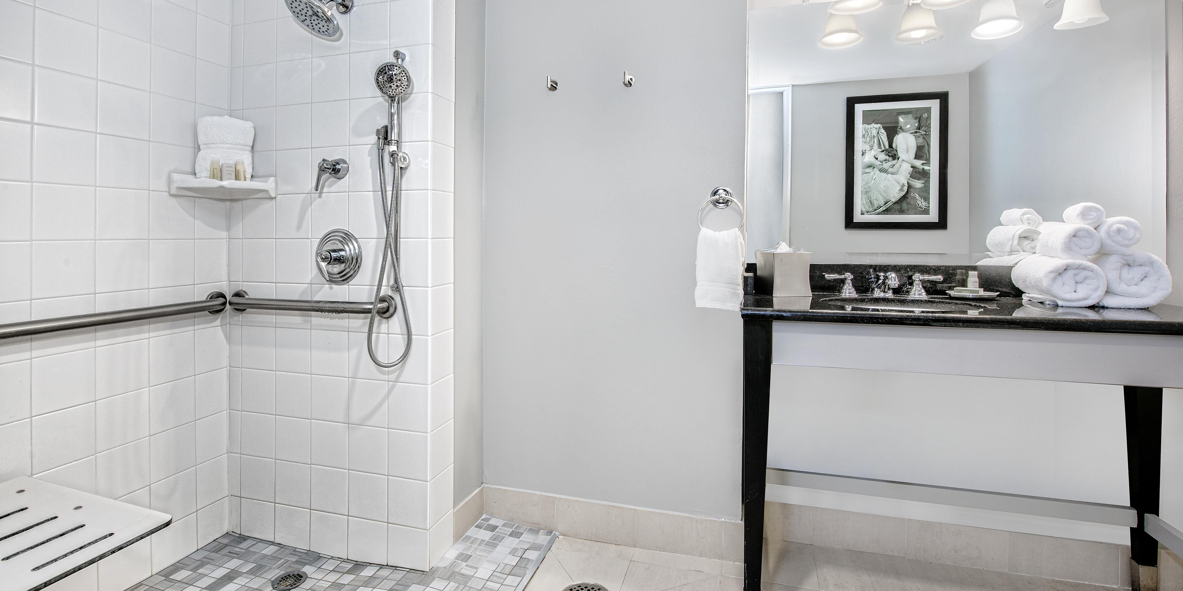 Refresh in a spacious ADA compliant bathroom with roll-in shower.