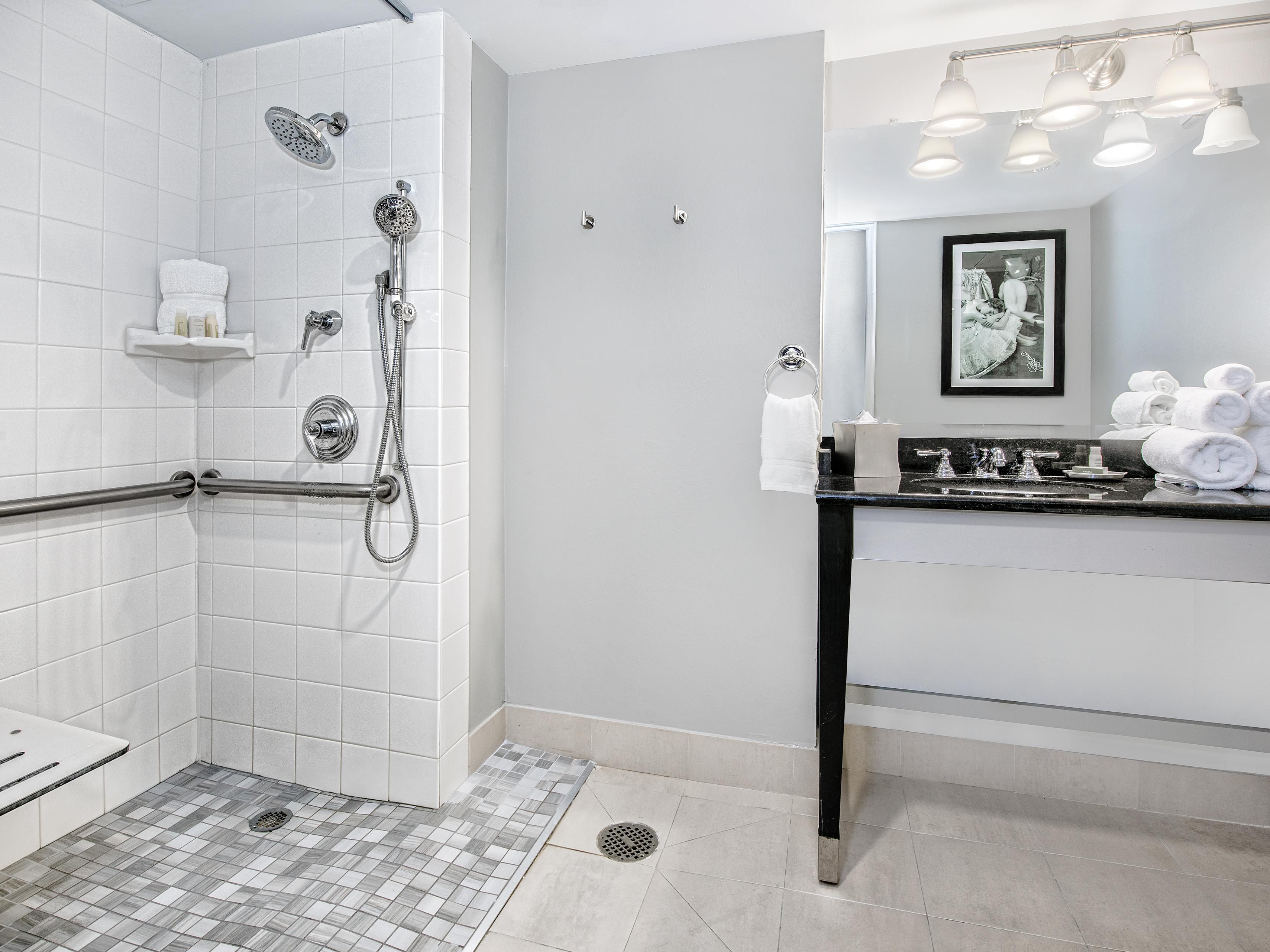 Refresh in a spacious ADA compliant bathroom with roll-in shower.