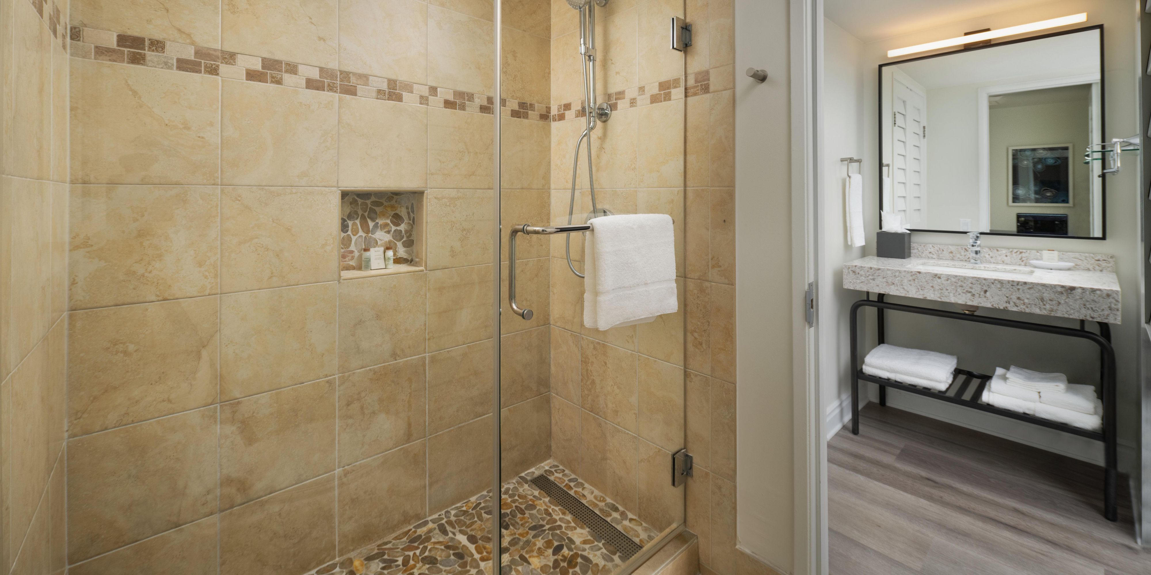 Our Deluxe bathrooms feature a luxurious rain head shower.