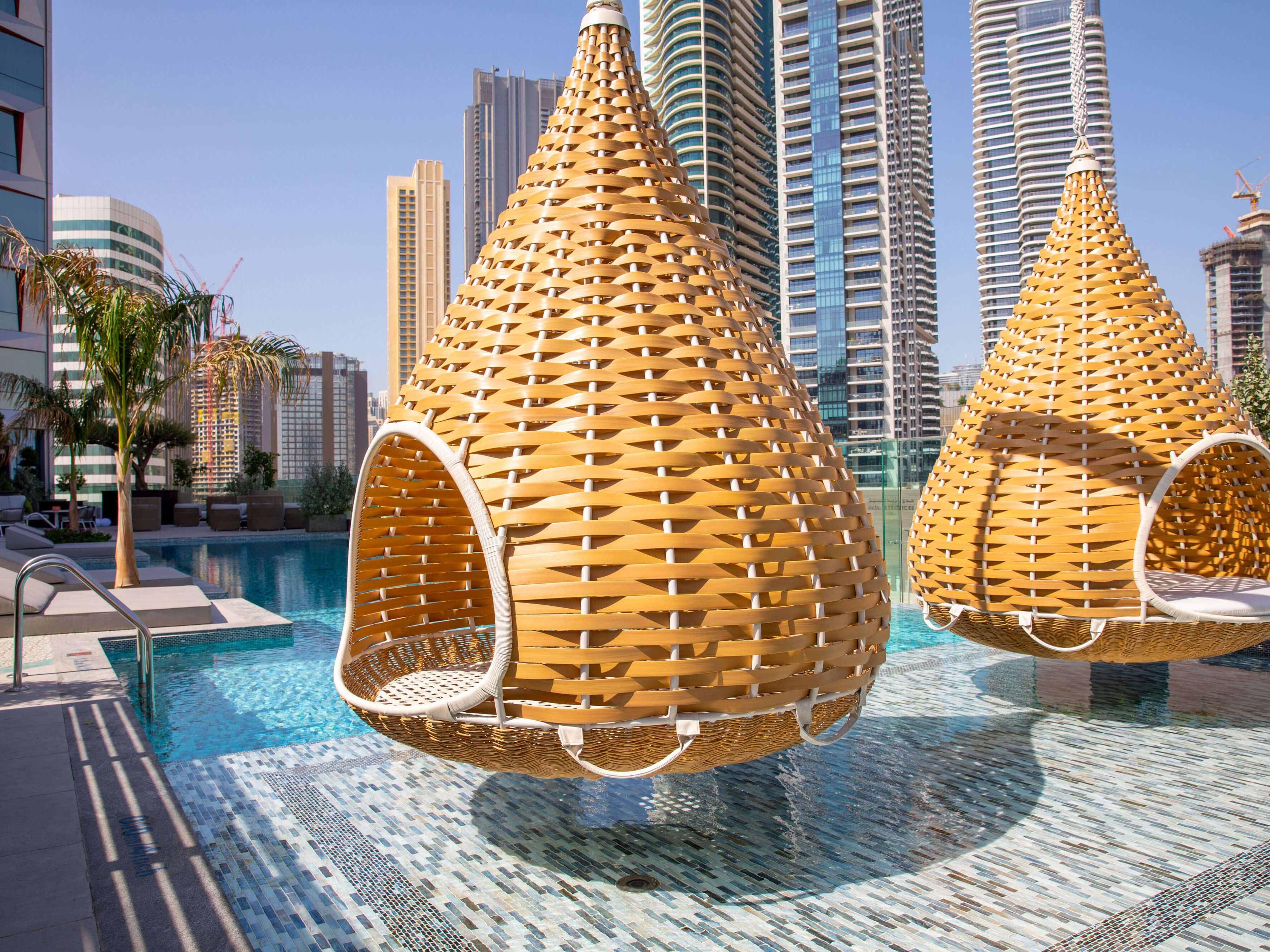Hanging pods by the outdoor pool at Hotel Indigo Dubai Downtown