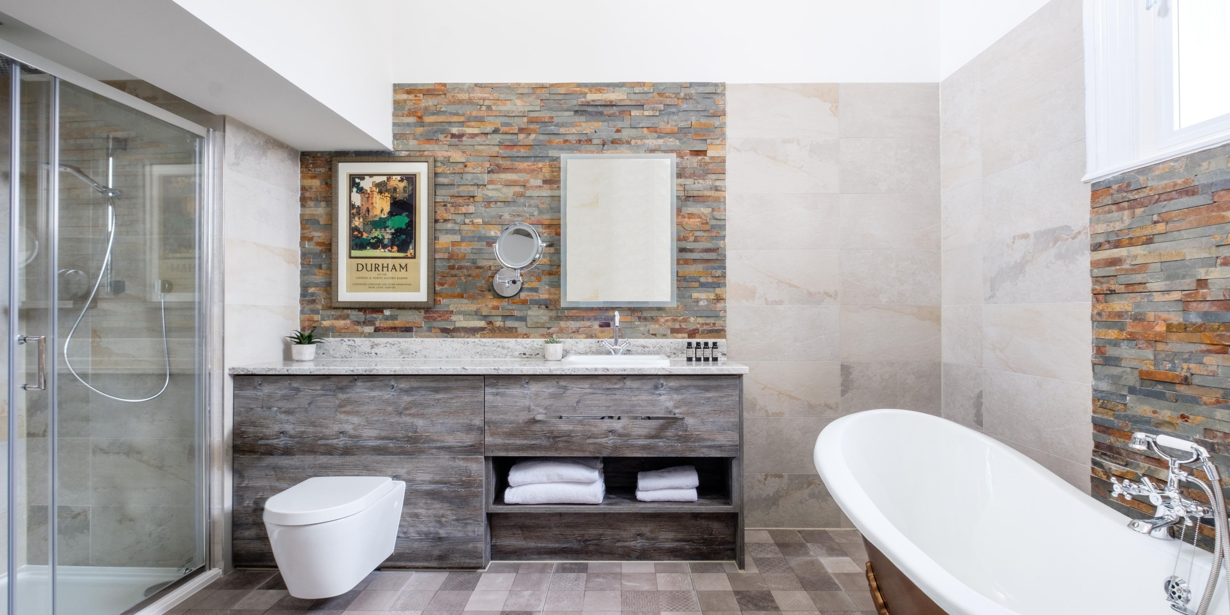 Spacious master bathroom with vintage tub and rainfall shower