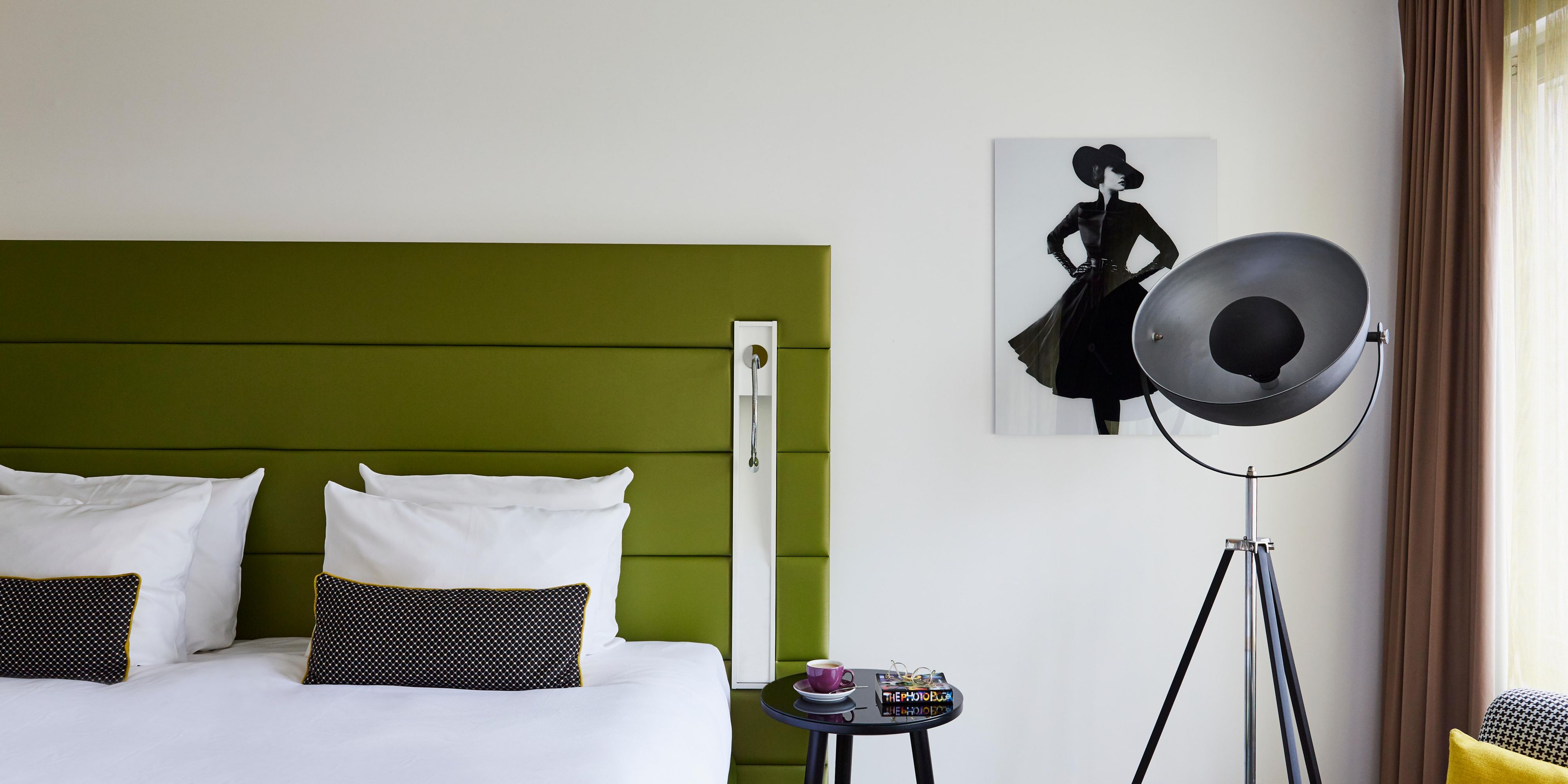 Boxspring bed and fashion-themed art in a King Superior room.