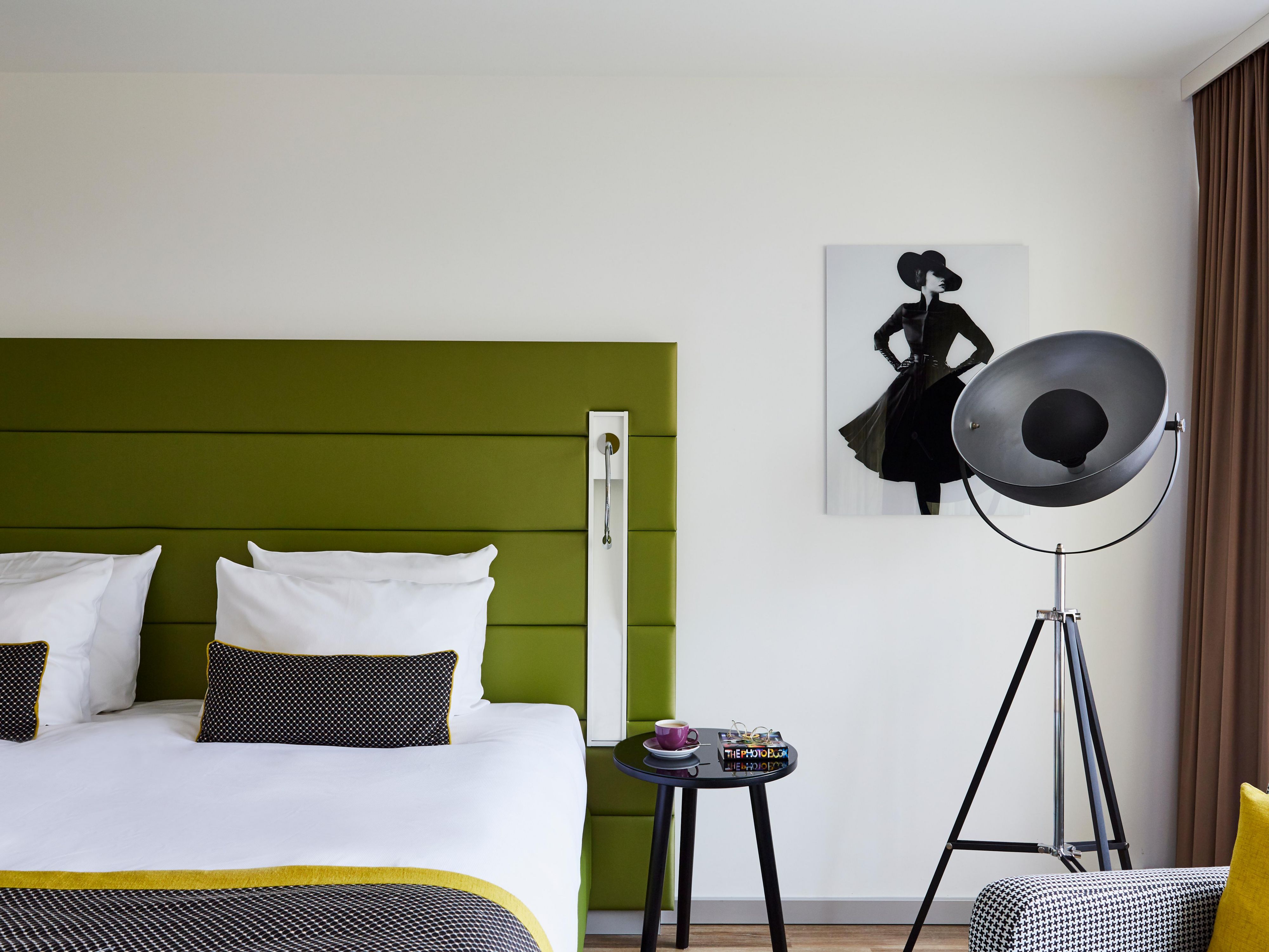 Boxspring bed and fashion-themed art in a King Superior room.