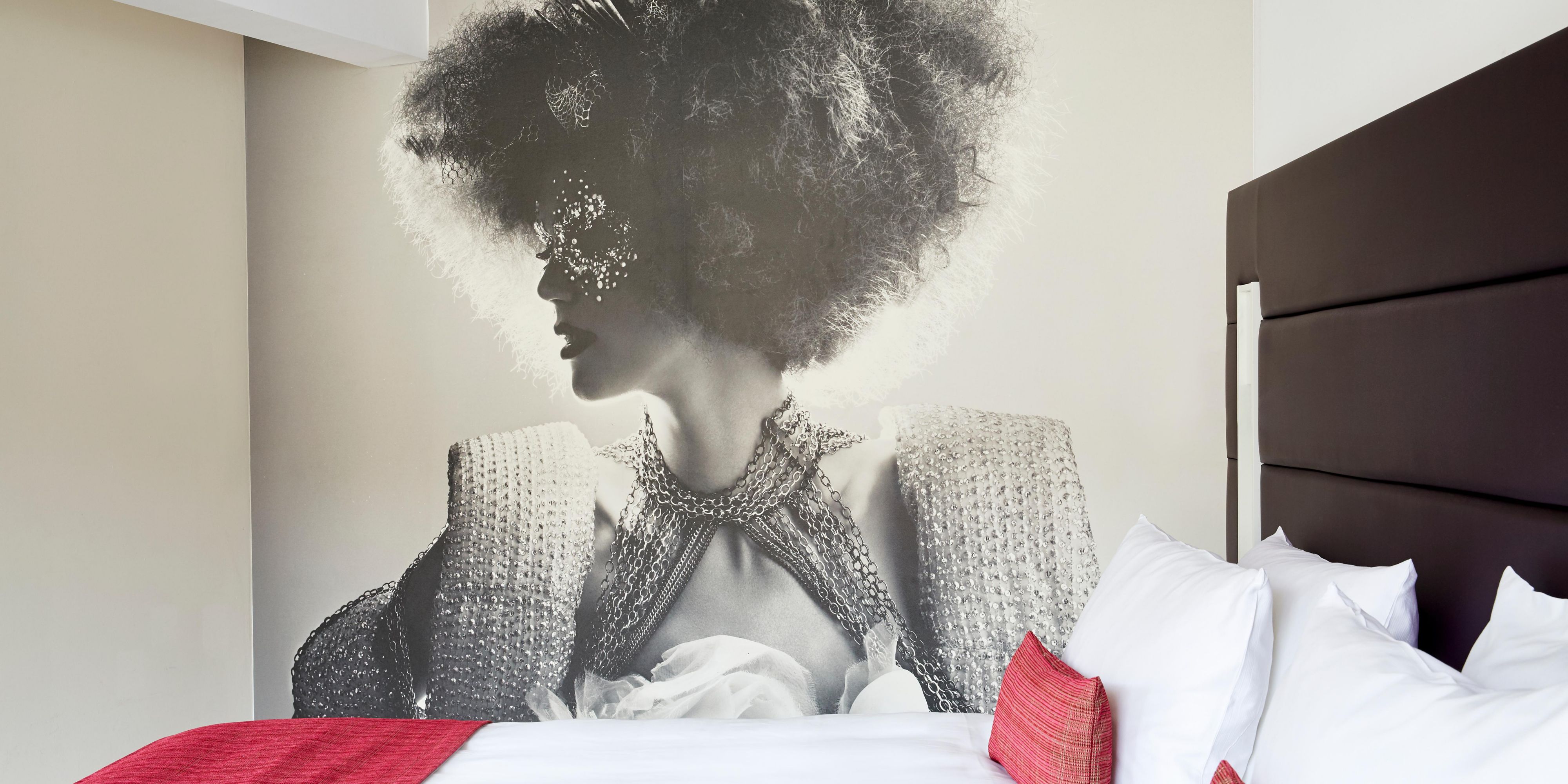 Striking, fashion-themed artwork in a King Superior guest room.
