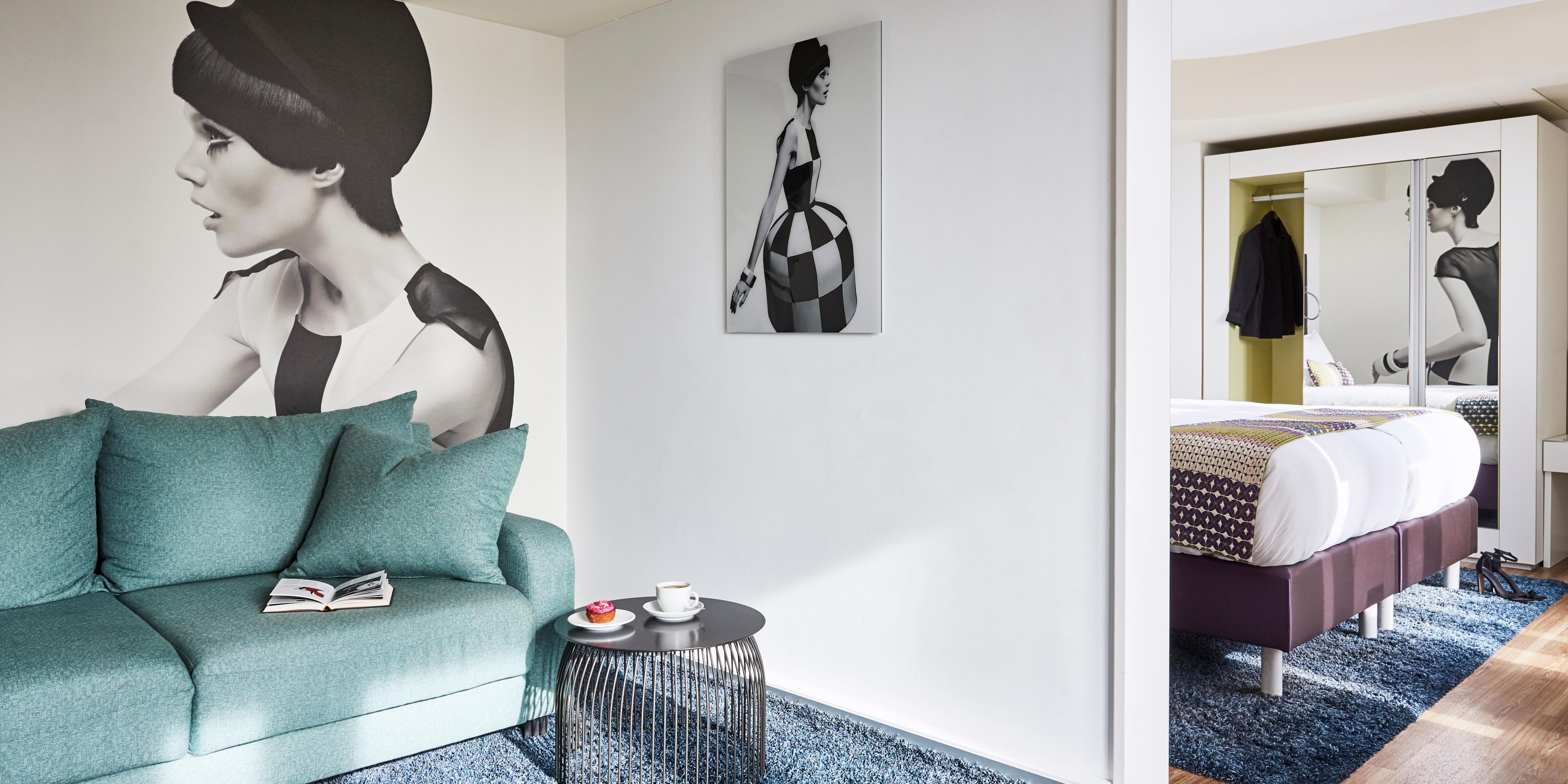 A separate living area in a plush suite, with a sofa and table.