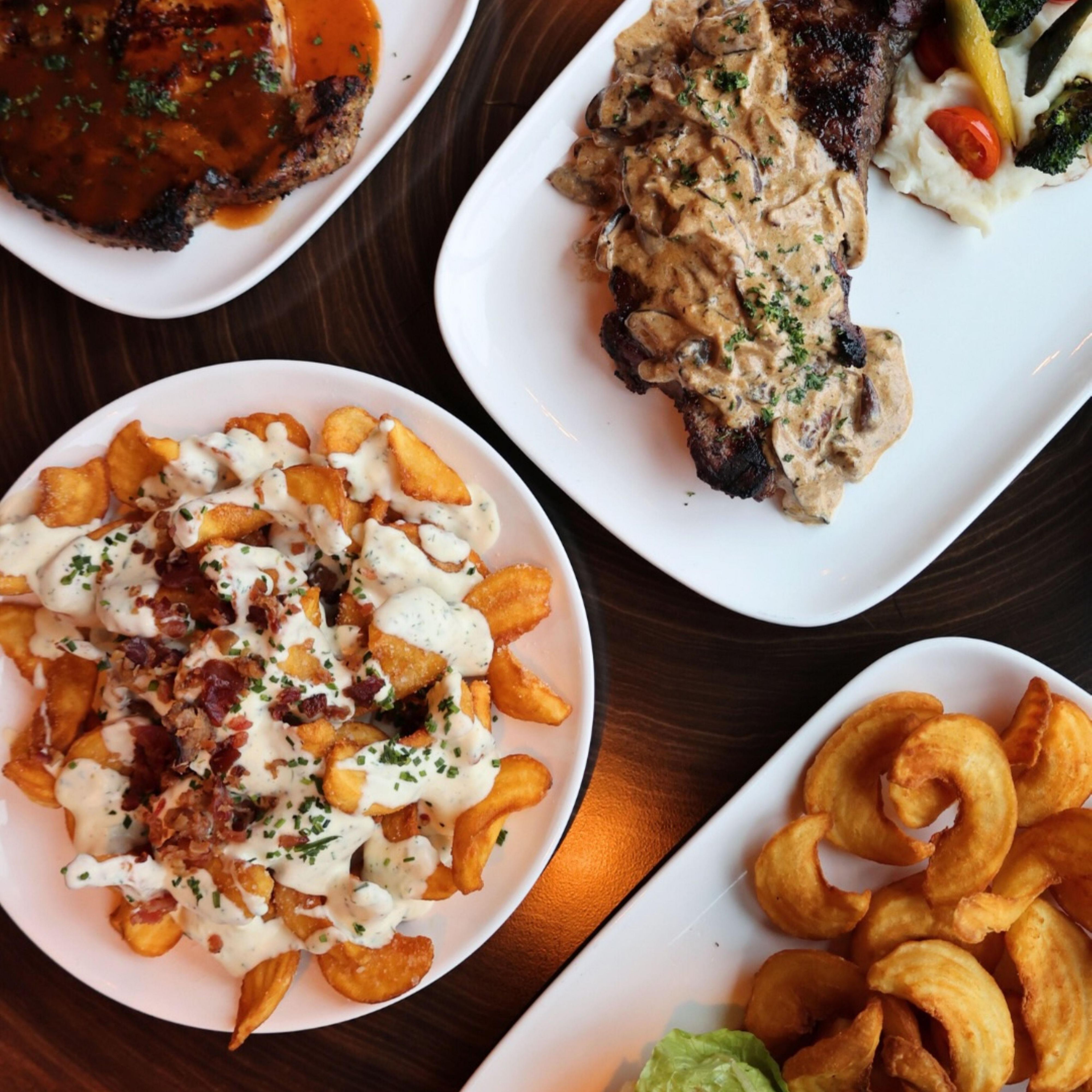 Assorted restaurant dishes served on white plates