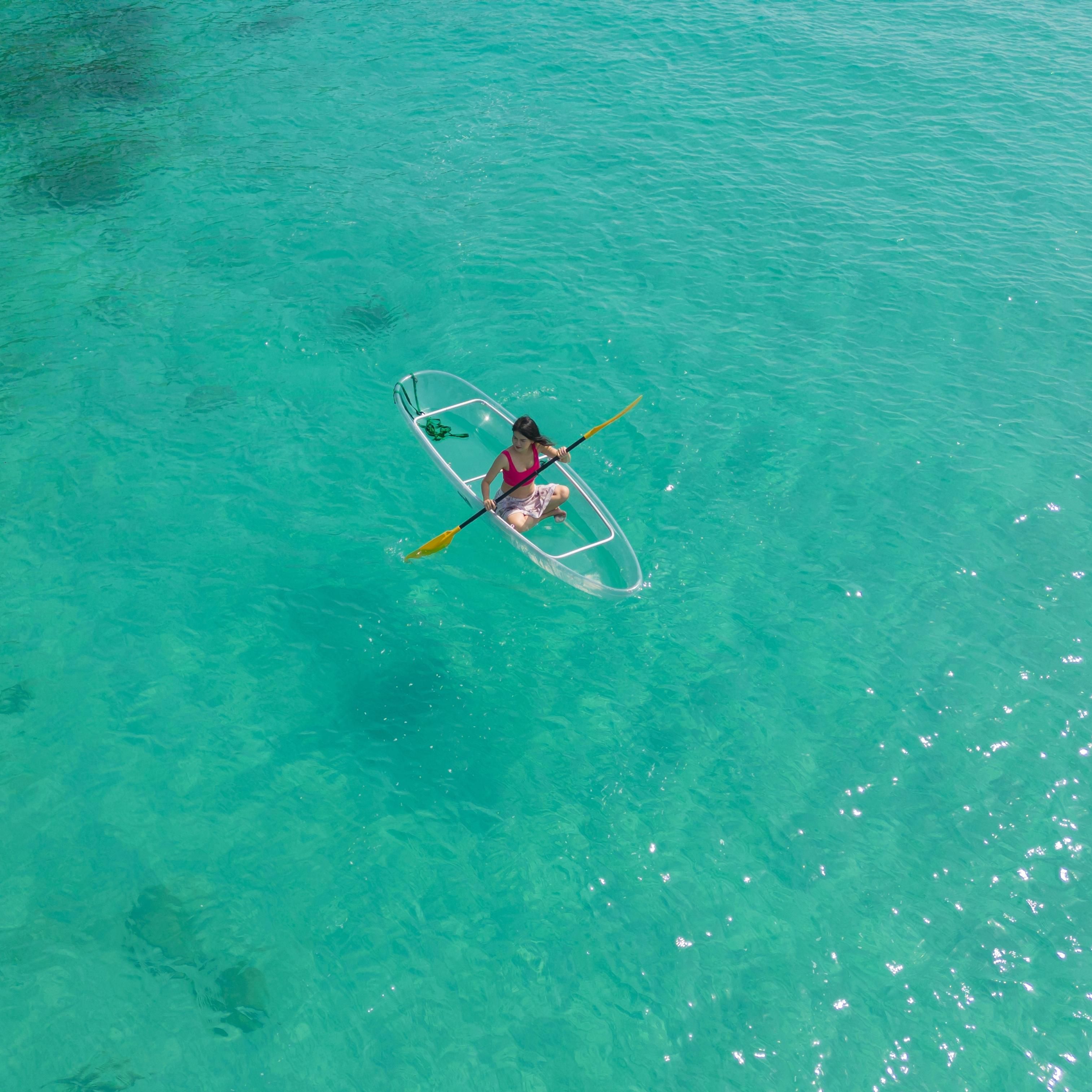 Woman in clear boat in ocean
