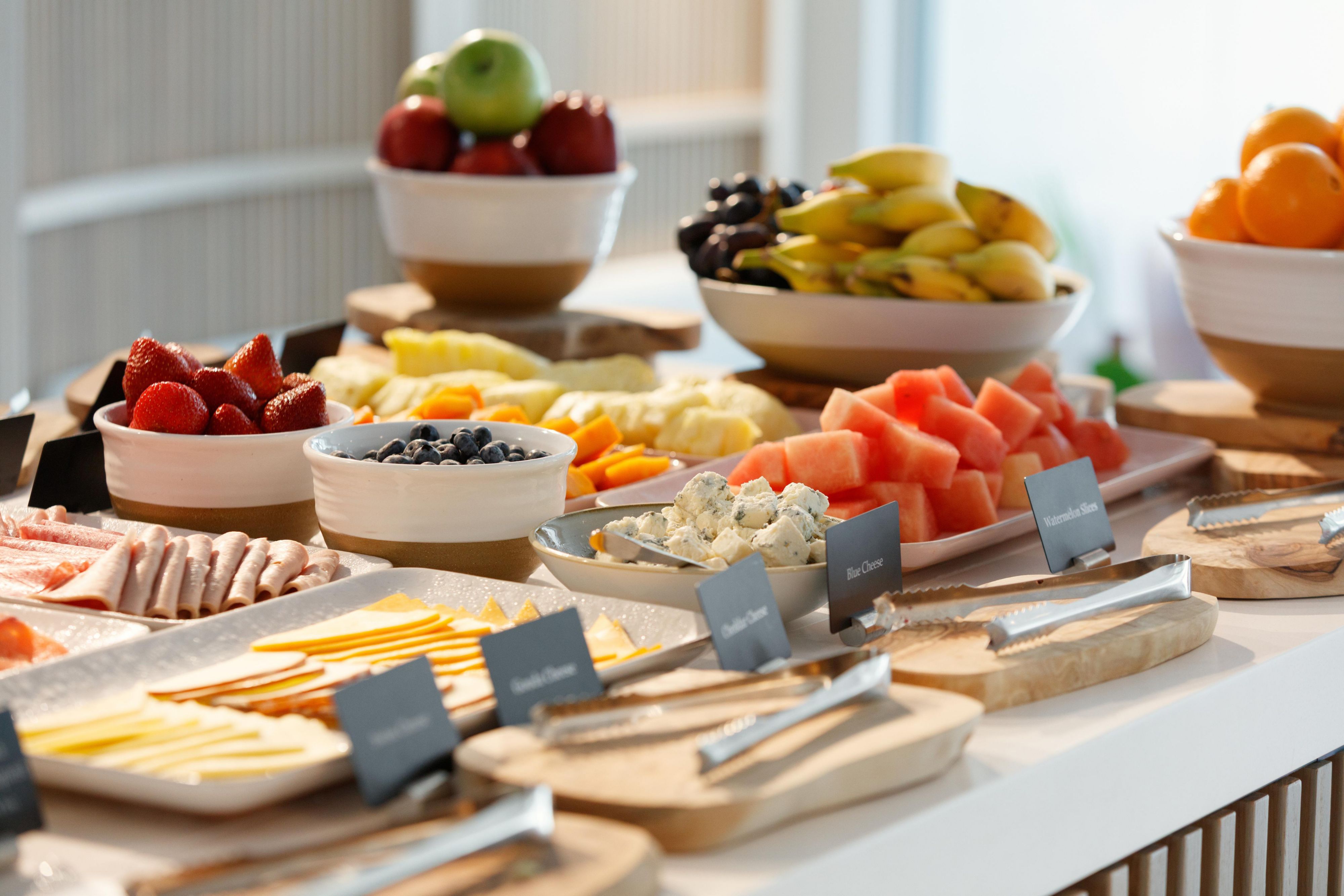 Fresh fruit, cheeses, and breakfast selections on display