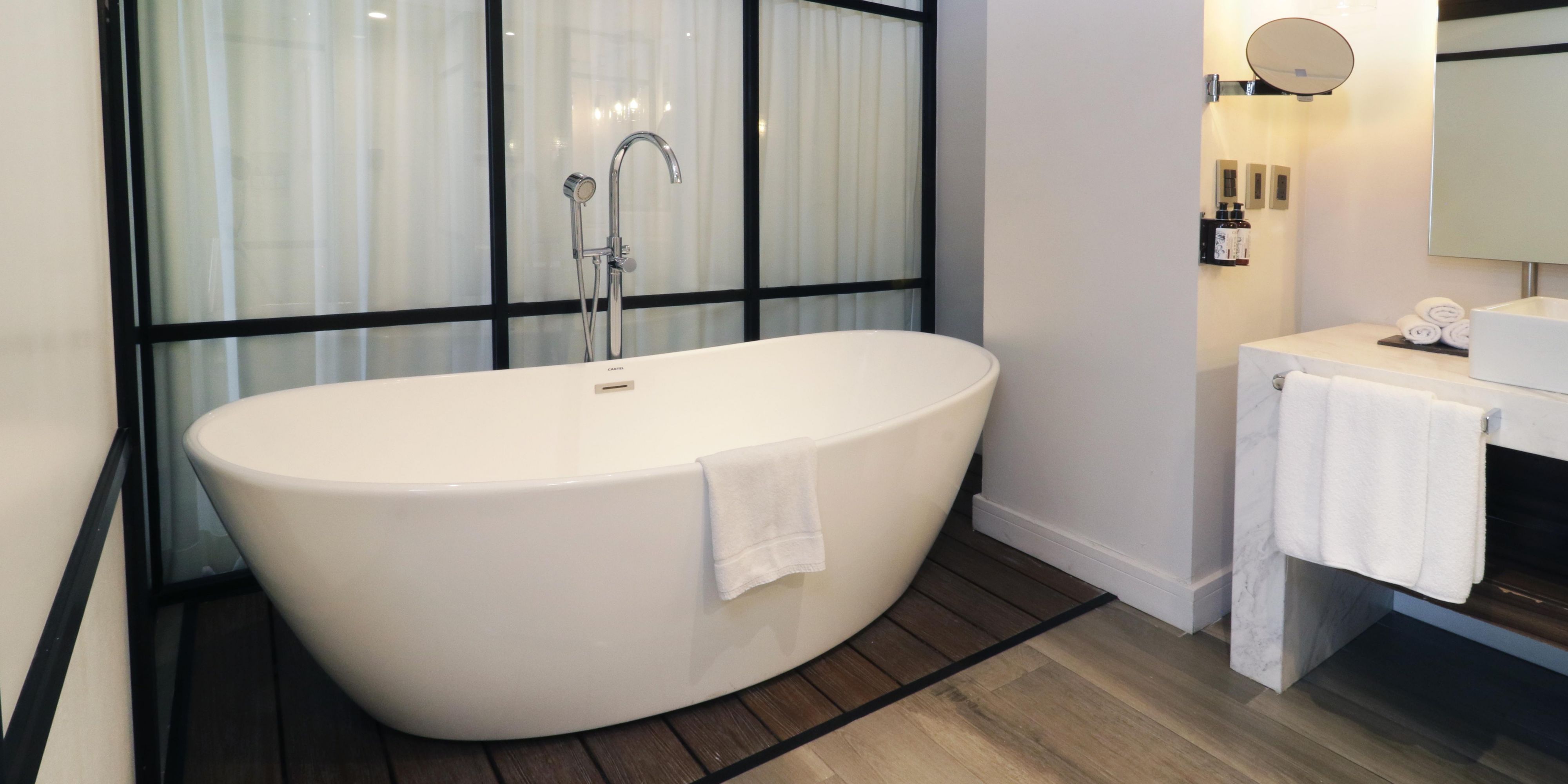Relax in our marble-finished bathroom with mini bathtub.