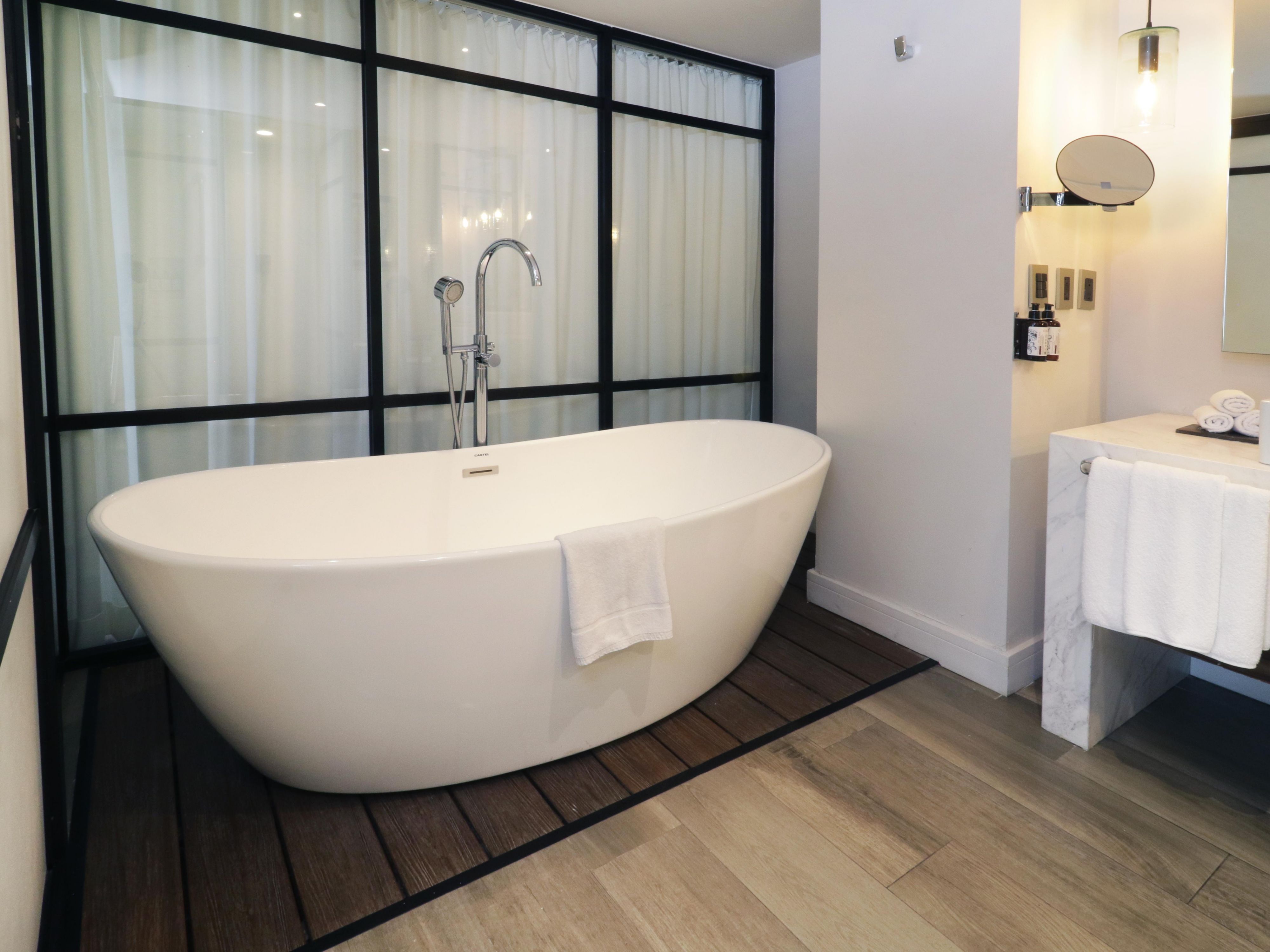 Relax in our marble-finished bathroom with mini bathtub.