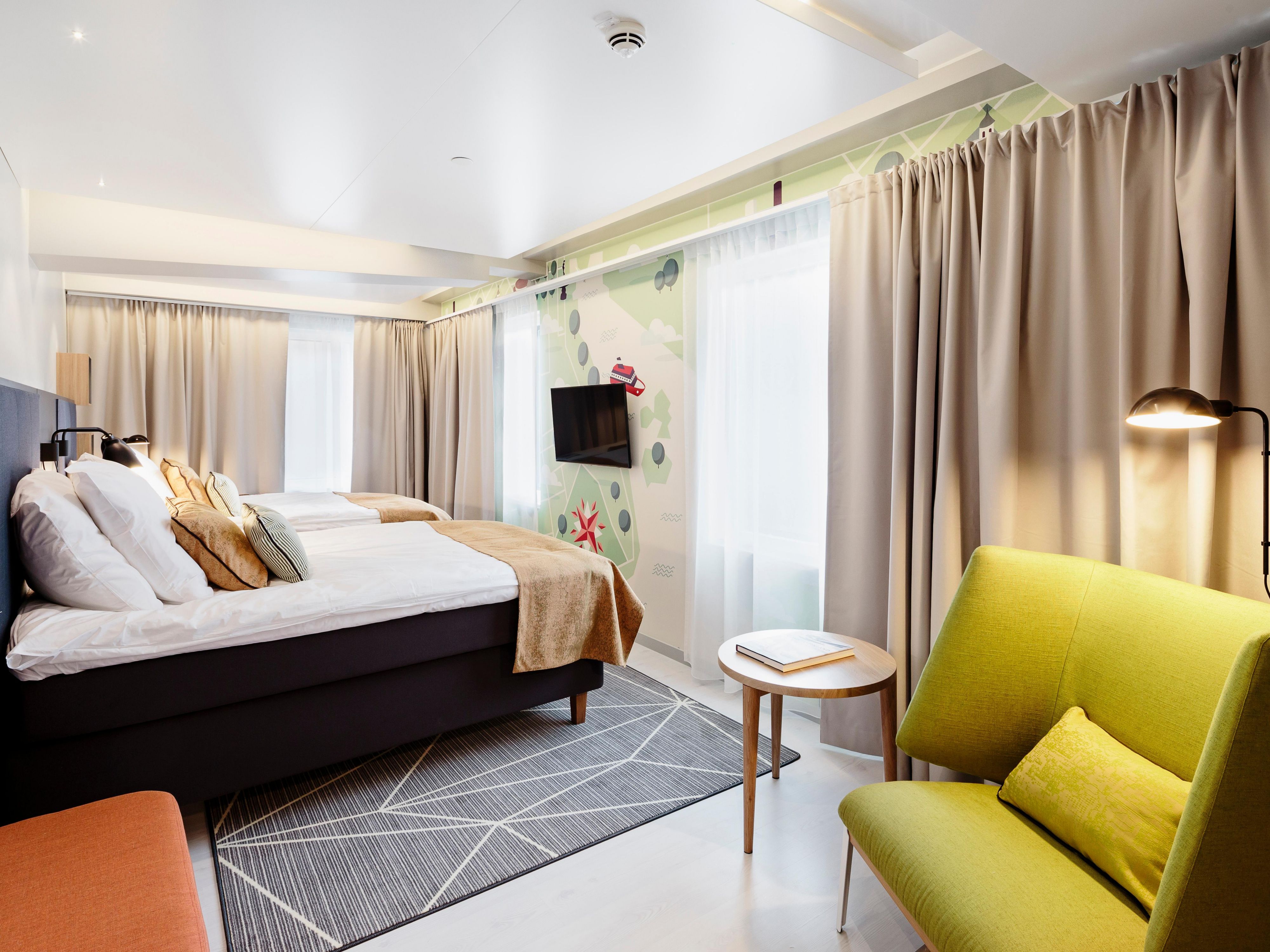 A bright Standard room with two single beds