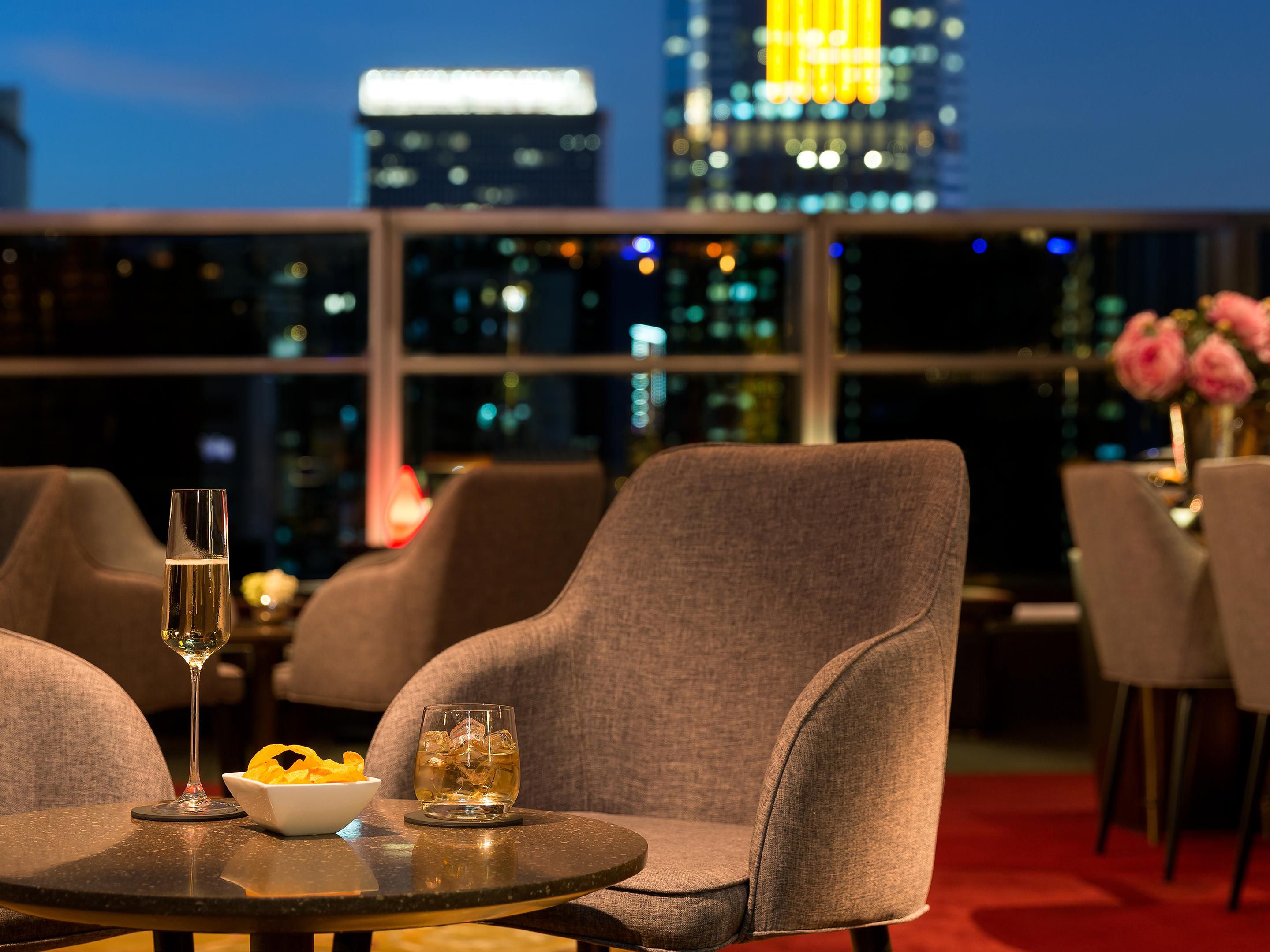 Unwind at Skybar, our rooftop venue overlooking the Wan Chai cityscape. Guests can enjoy free-flow red and white wines daily from 15:00 to 21:00, with rotating wine themes every two months featuring both New World and Old World selections. The venue offers a relaxing setting for evening drinks with views of the surrounding city.