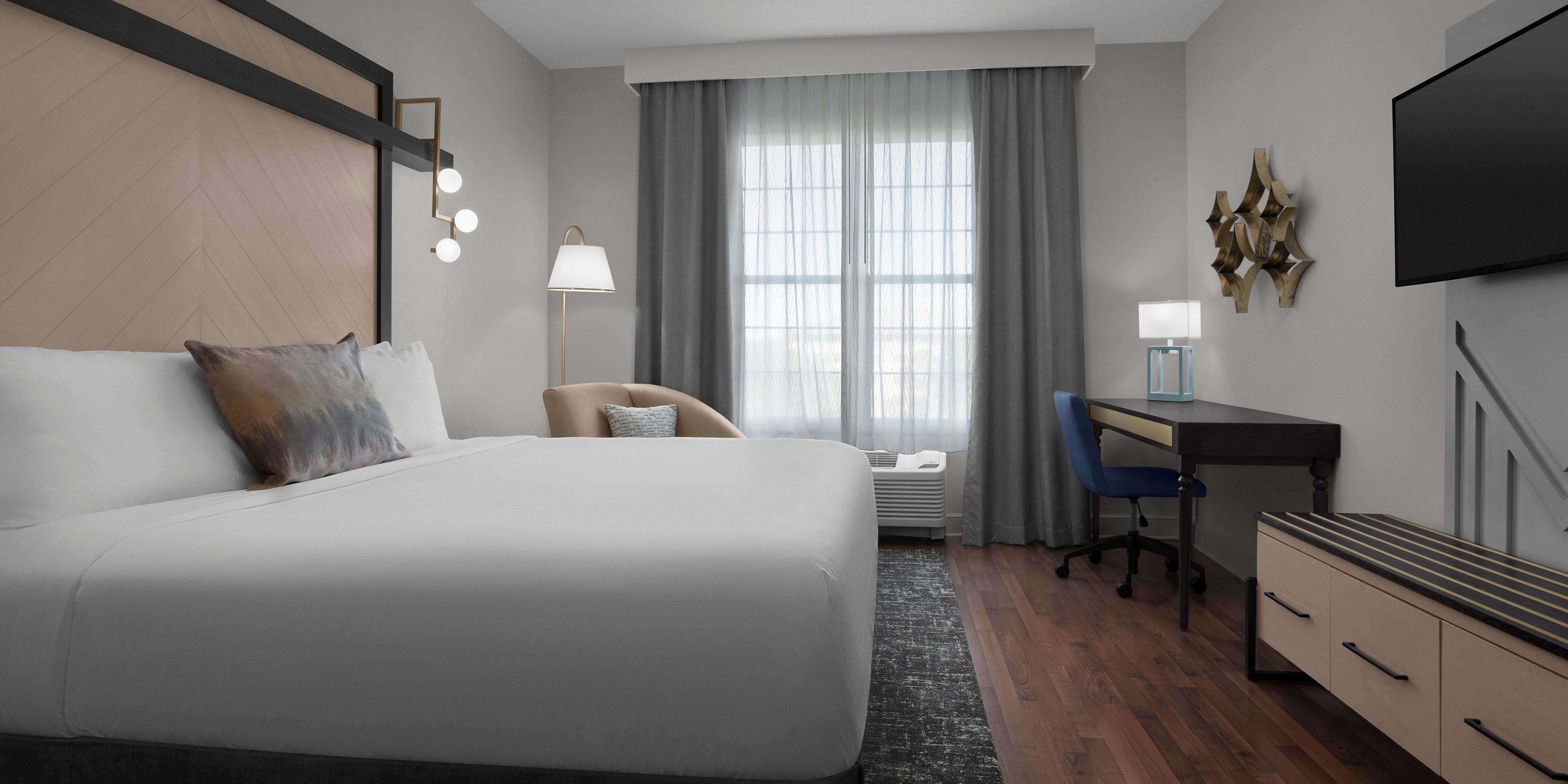 Hotel Indigo Jacksonville Deerwood Park king guest bedroom.